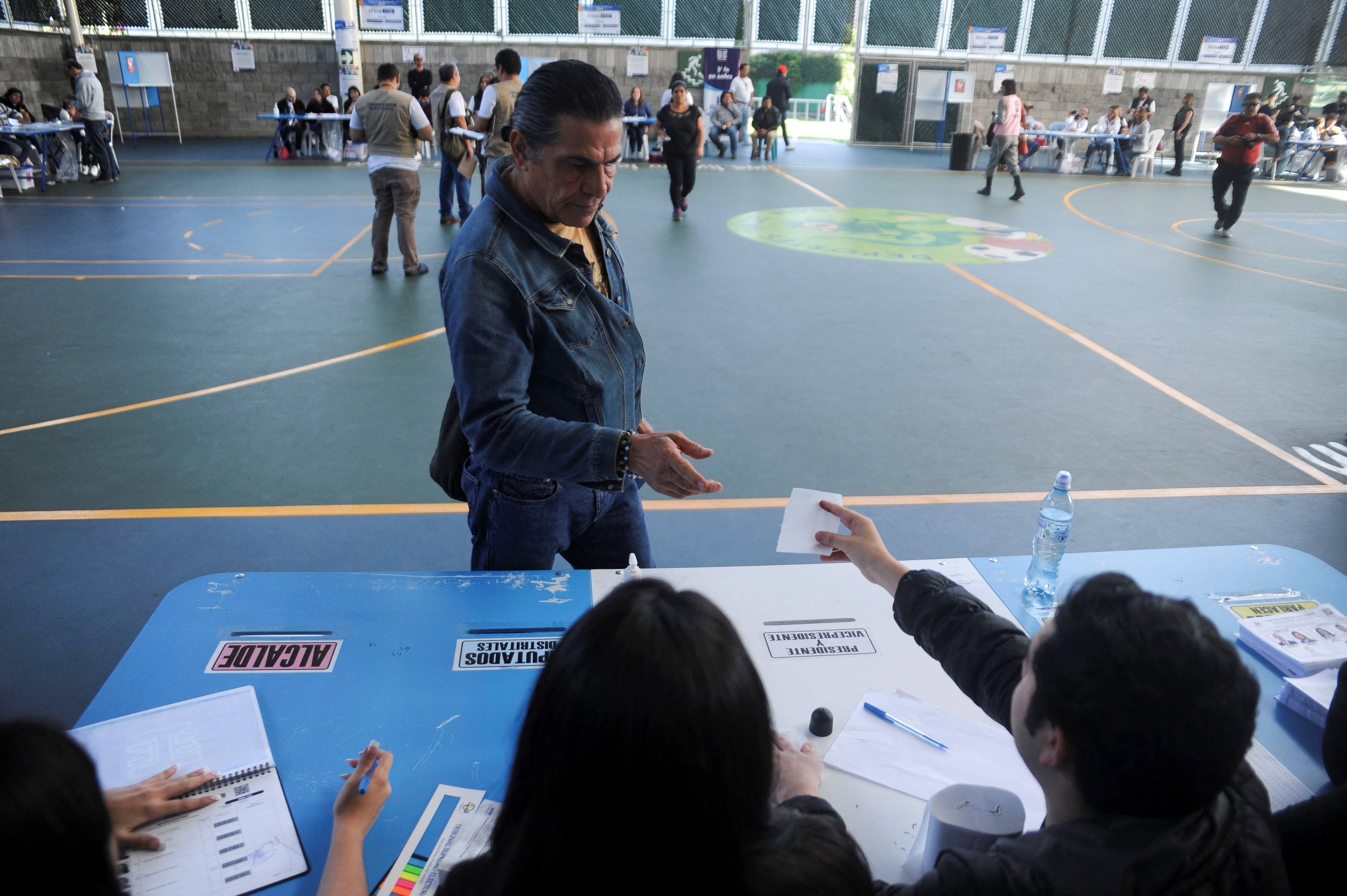 A person casts a vote at a polling station during the presidential run-off election, in Guatemala City, Guatemala August 20, 2023.