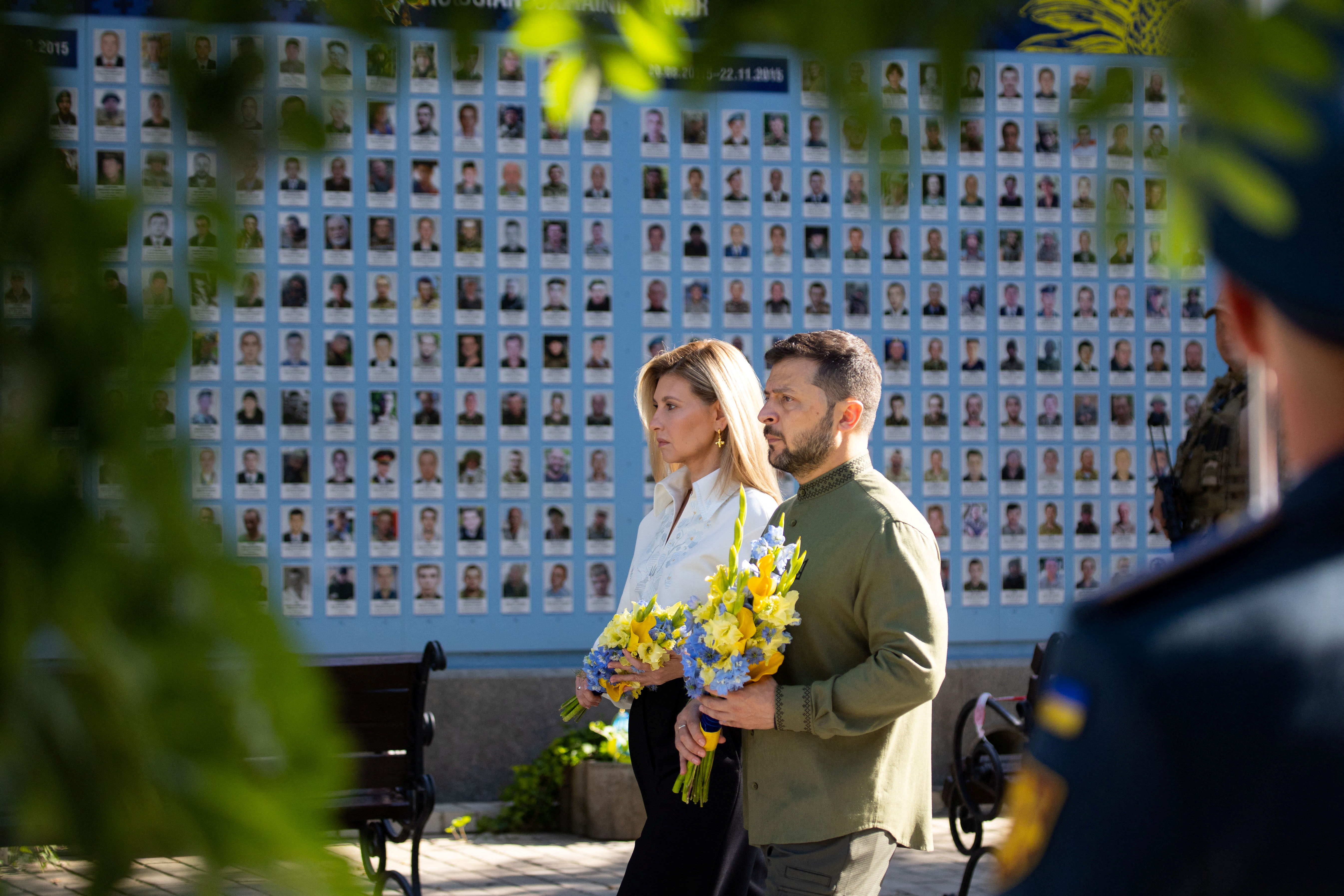 Ukrainian president Volodymr Zelenskyy and his wife Olena on the country's independence day. They are walking in the sun carrying flowers to lay at the Memory Wall of Fallen Defenders of Ukraine.