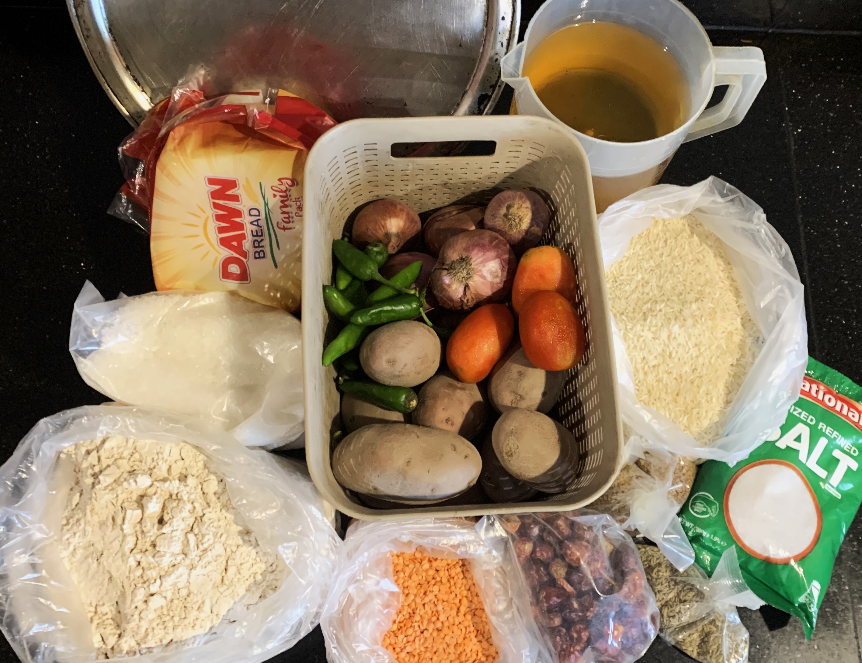 A photo of groceries with grains, spices and vegetables.