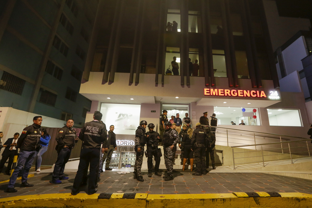 Police guard the hospital where several of the injured were taken after an attack against presidential candidate Fernando Villavicencio in Quito, Ecuador, Wednesday, Aug. 9, 2023. Villavicencio was killed as he entered a vehicle after a campaign rally, outside a school in Quito. (AP Photo/Juan Diego Montenegro)