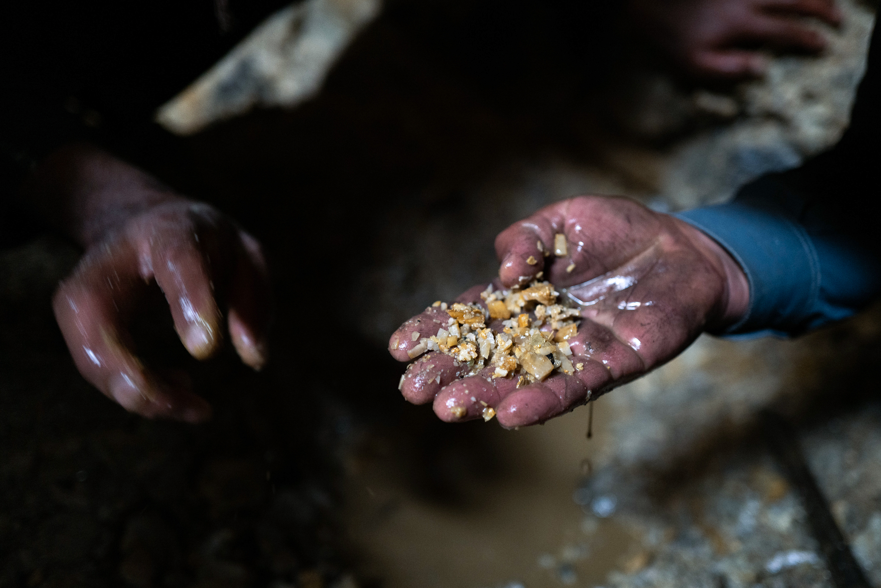 The miners search for valuable stones by hand