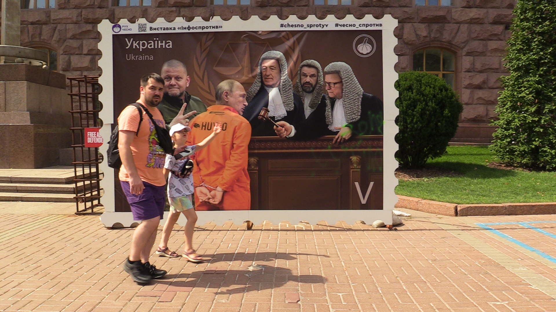 Ukrainians pass an image of President Putin