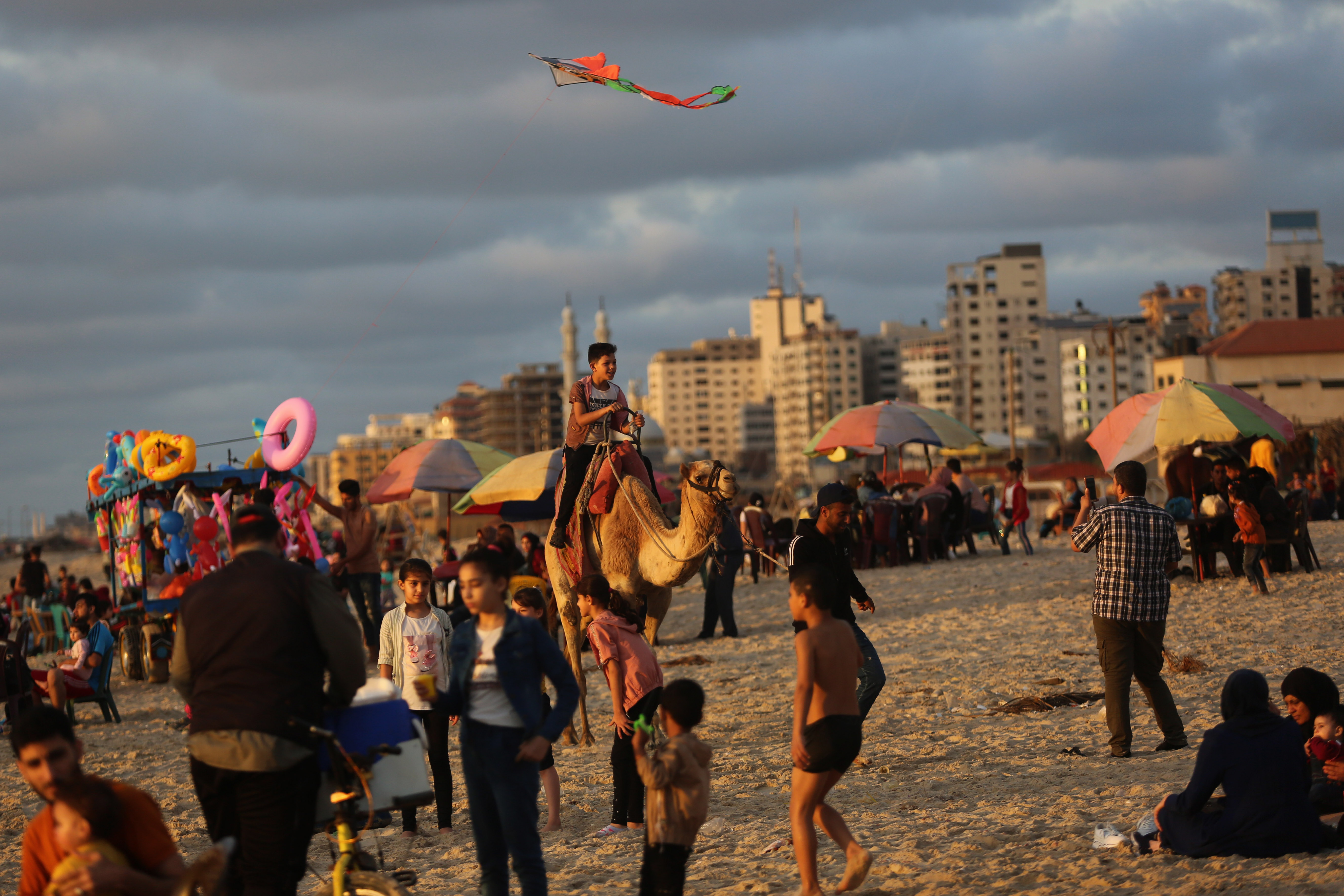 camel giving rides near beachgoers