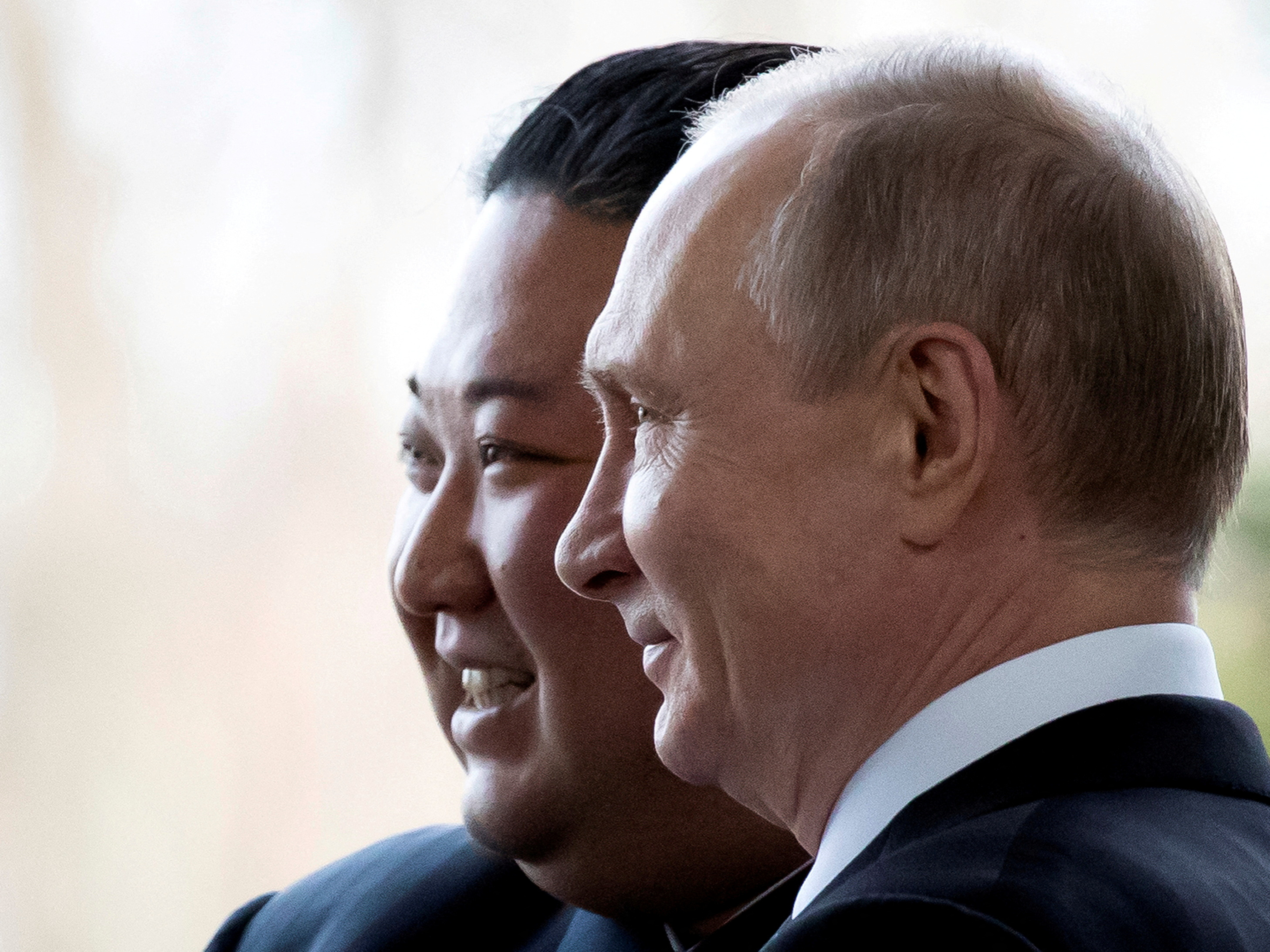 Kim Jong Un and Vladimir Putin in profile, side by side.