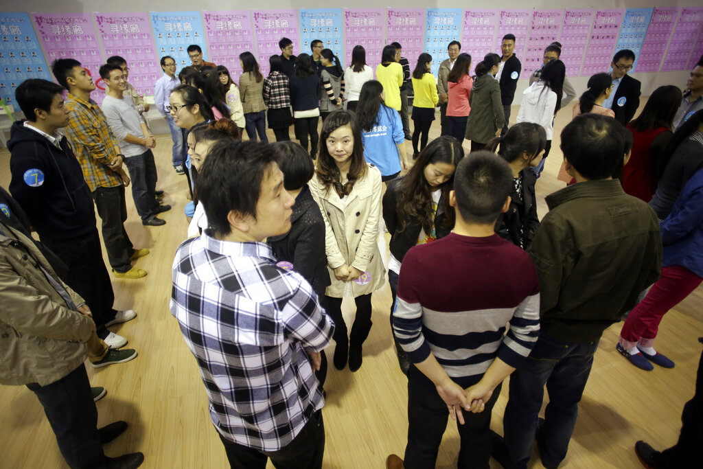 Participants take part in a bachelor's meeting event during a mass match-making event ahead of Singles Day in Shanghai, China, Saturday, Nov. 9, 2013. Singles Day was begun by Chinese college students in the 1990s as a version of Valentine's Day for people without romantic partners. The timing was based on the date Nov. 11, or "11.11" four singles. (AP Photo/Eugene Hoshiko)
