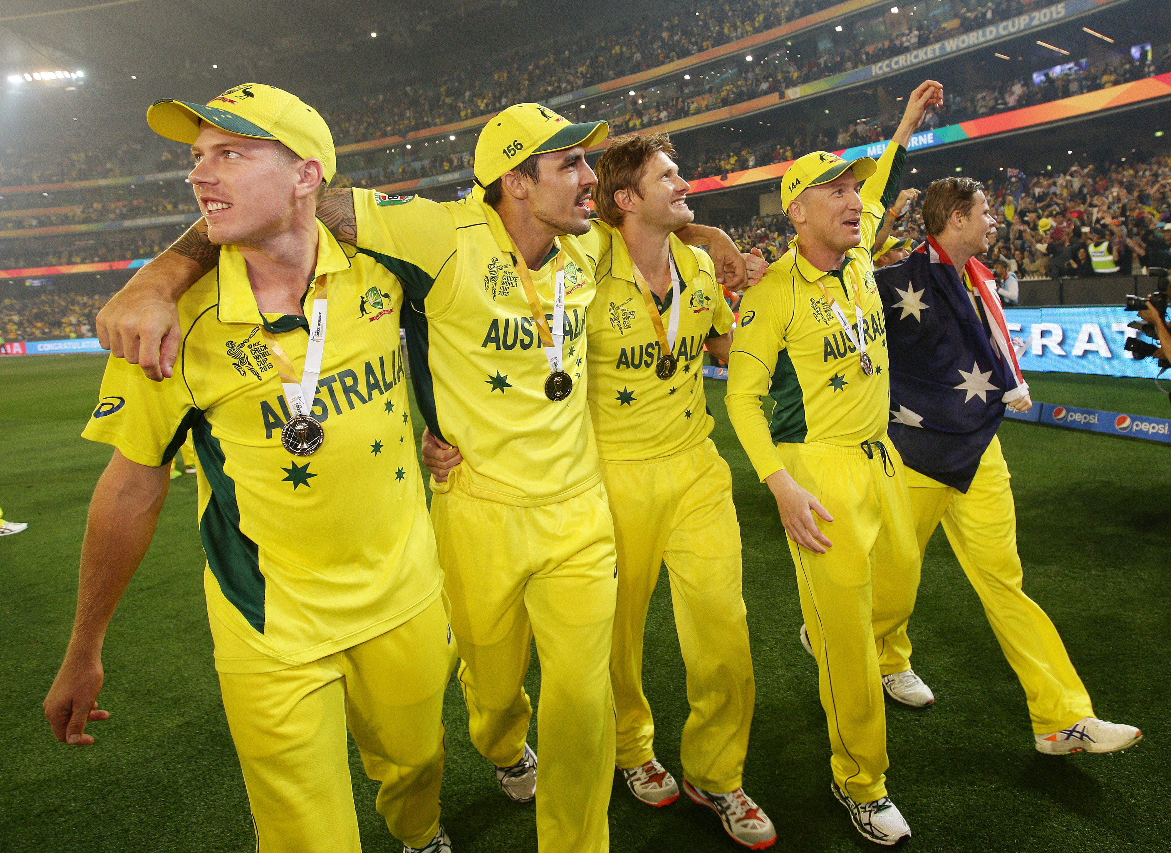 Australian players walk around the Melbourne Cricket Ground as they celebrate their seven wicket win over New Zealand in the Cricket World Cup final in Melbourne, Australia, Sunday, March 29, 2015.