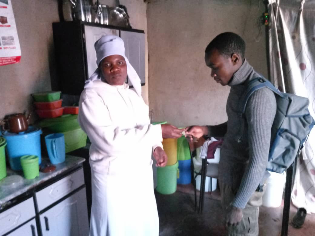 A photo of someone handing someone else a piece of paper.