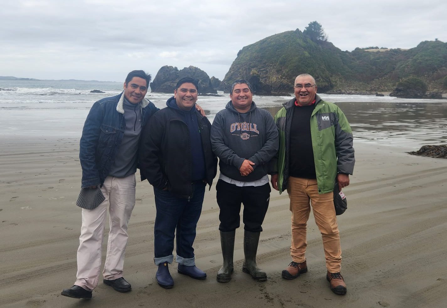 Four brothers pose for a photo on the beach in southern Chile.