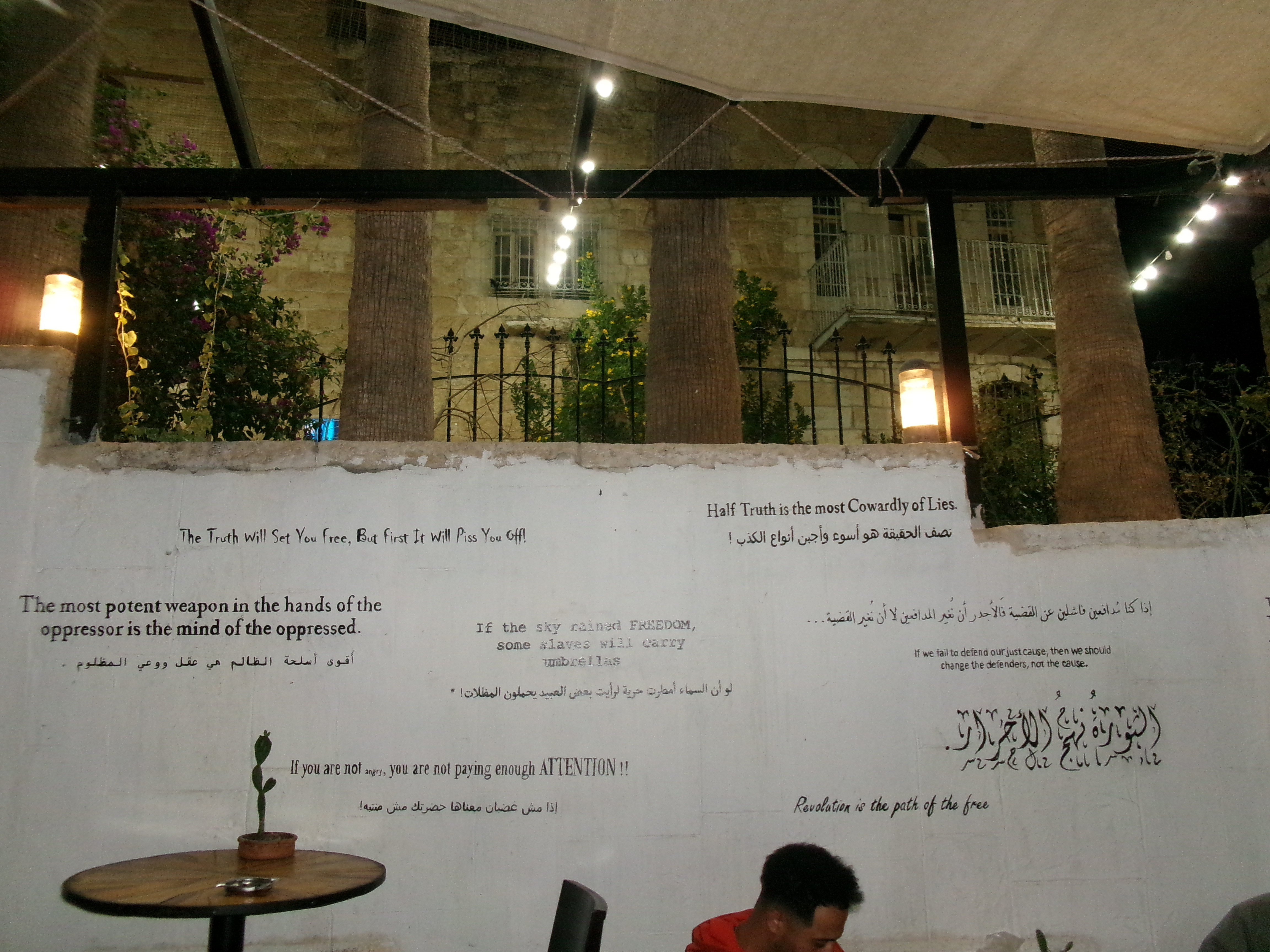 A wall with quotes on Palestine's liberation struggle at the Citadel restaurant in the West Bank on October 10, 2023 [Laila Shadid/Al Jazeera]