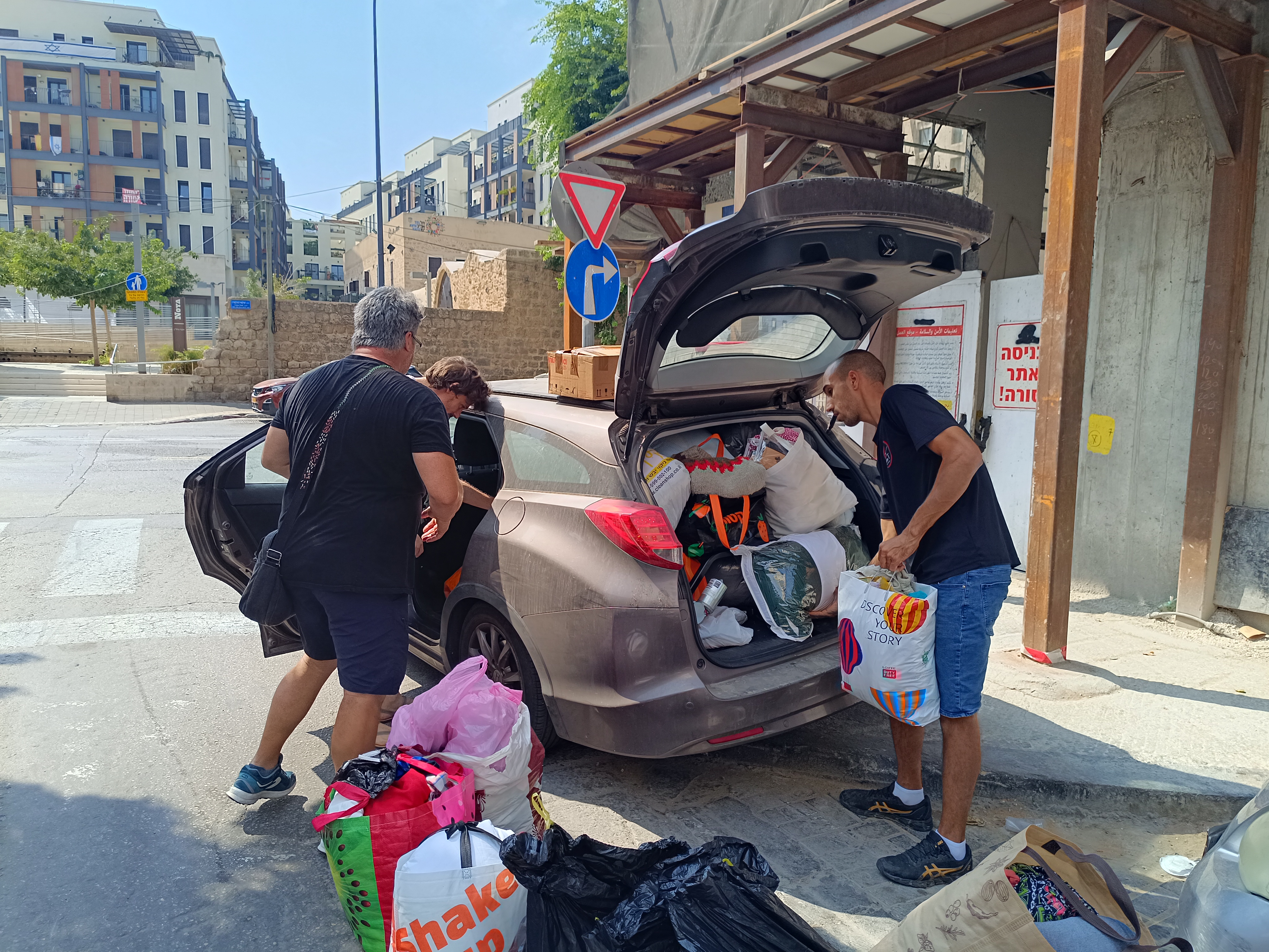 People drop off donated clothing and toys at a Tel Aviv hotel