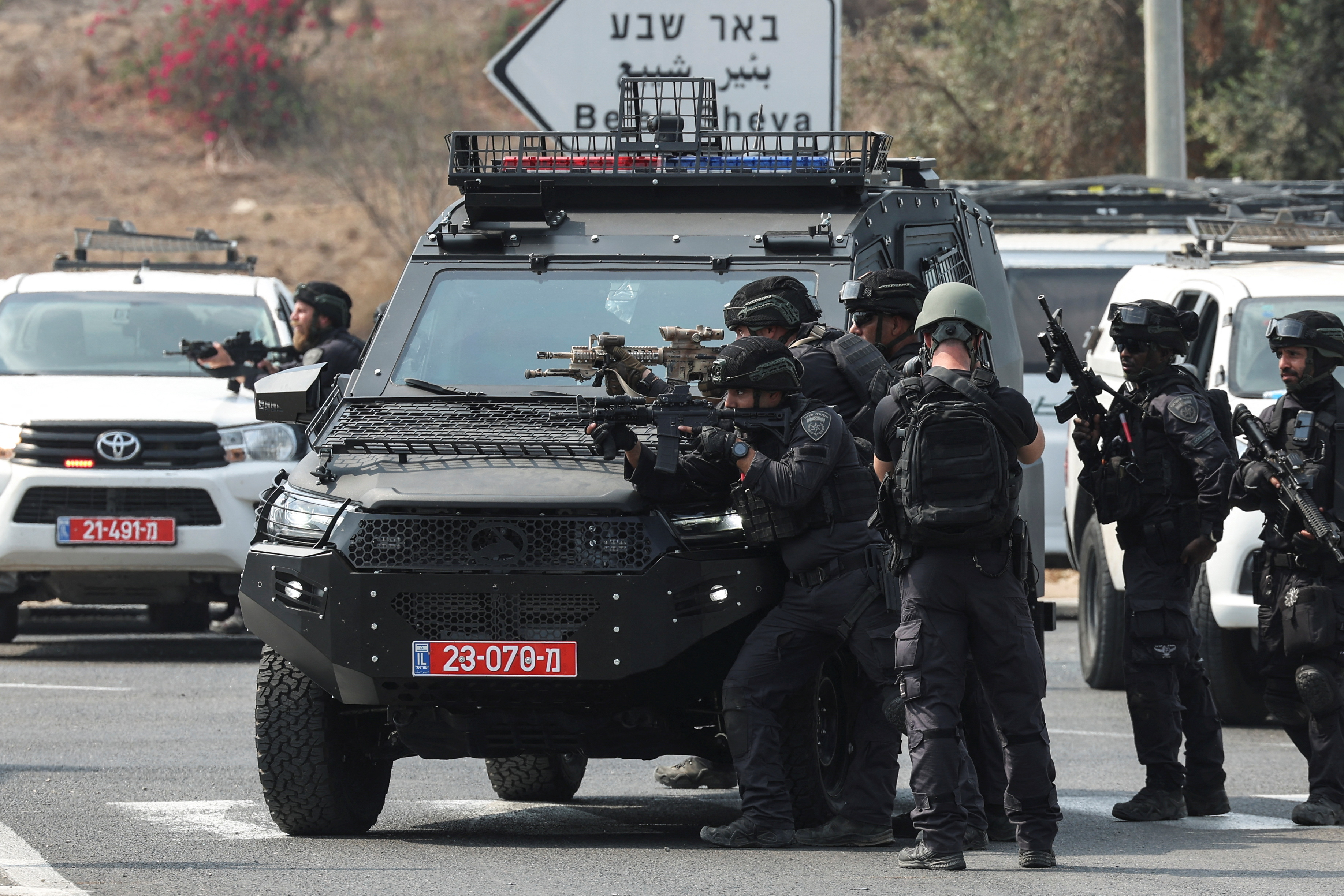 Israeli security stand in position on a road
