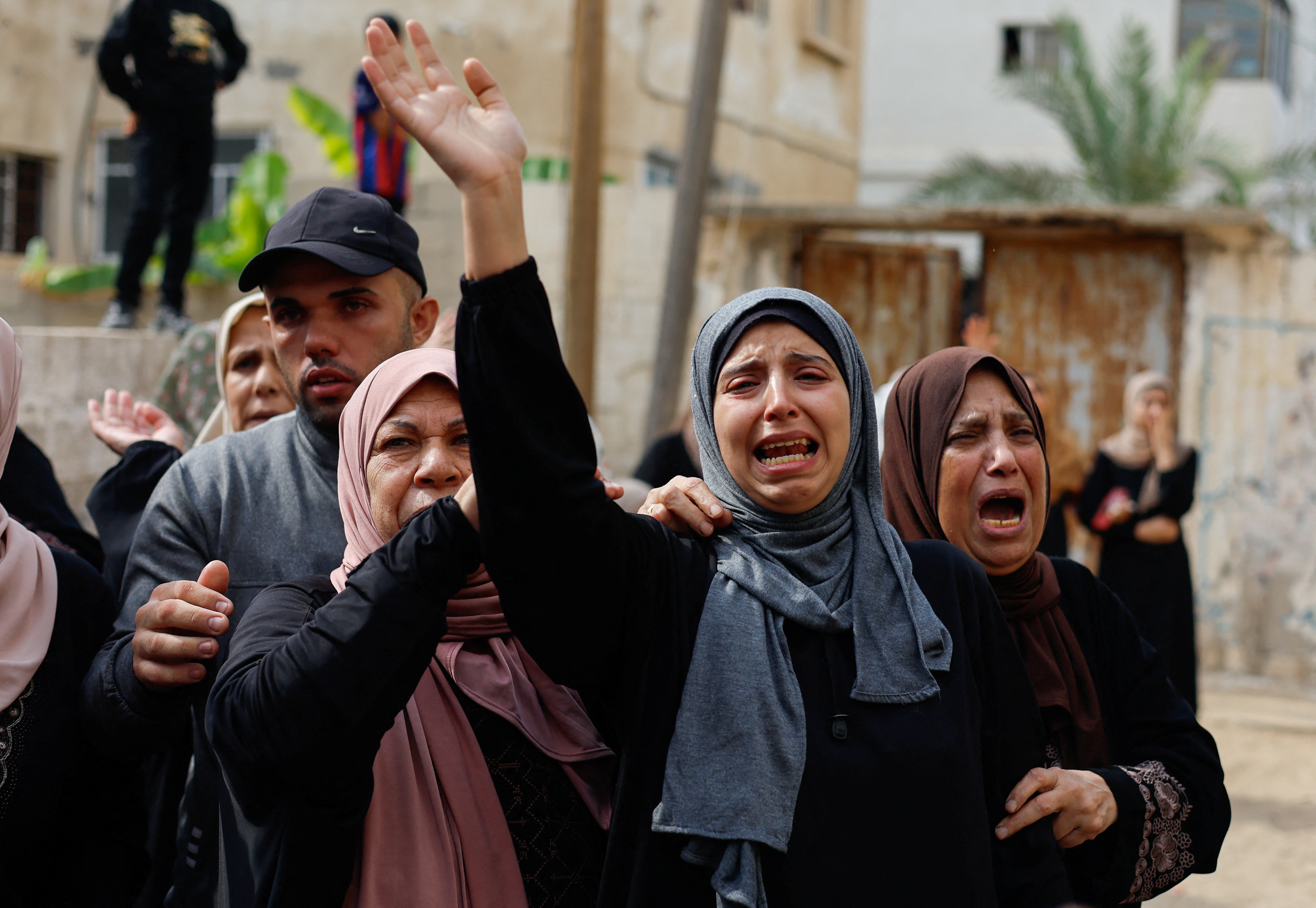 Relatives react as they attend the funeral of Palestinians from the Shamalkh family, who health officials said were killed in Israeli strikes, in Gaza City