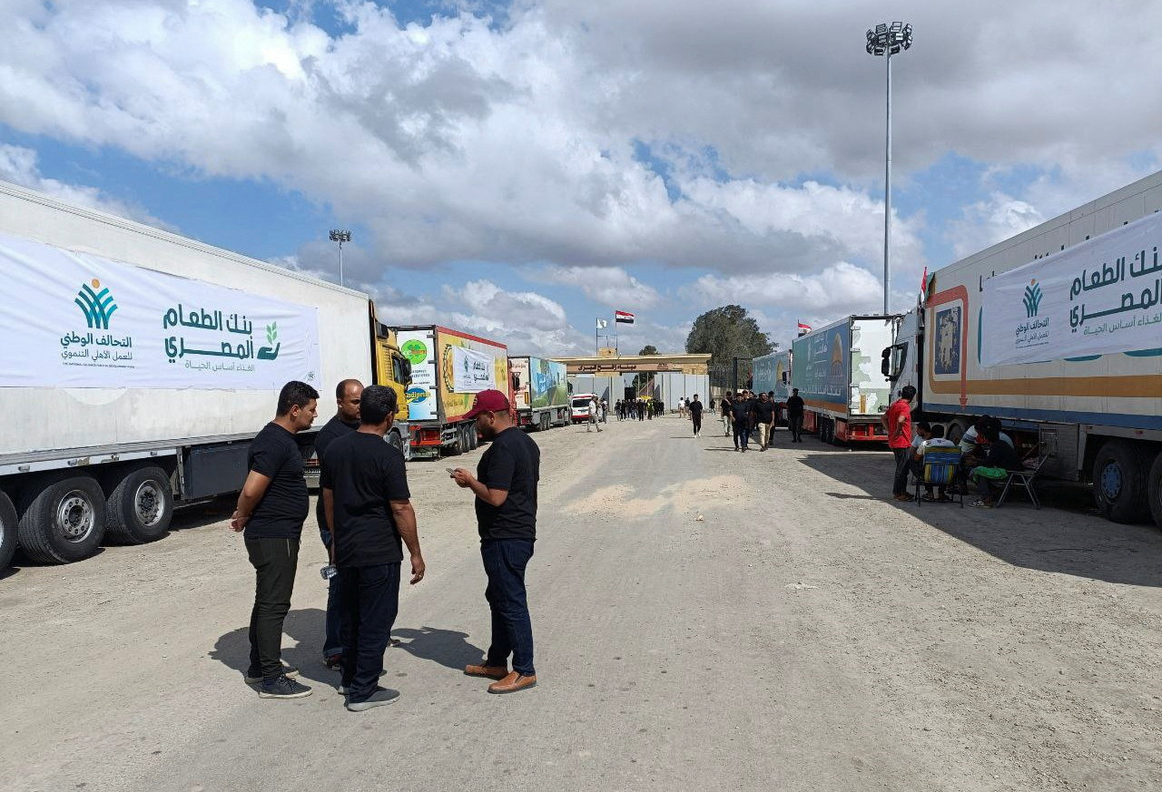 Trucks carrying humanitarian aid from Egyptian NGOs for Palestinians wait for the reopening of the Rafah crossing at the Egyptian side, to enter Gaza