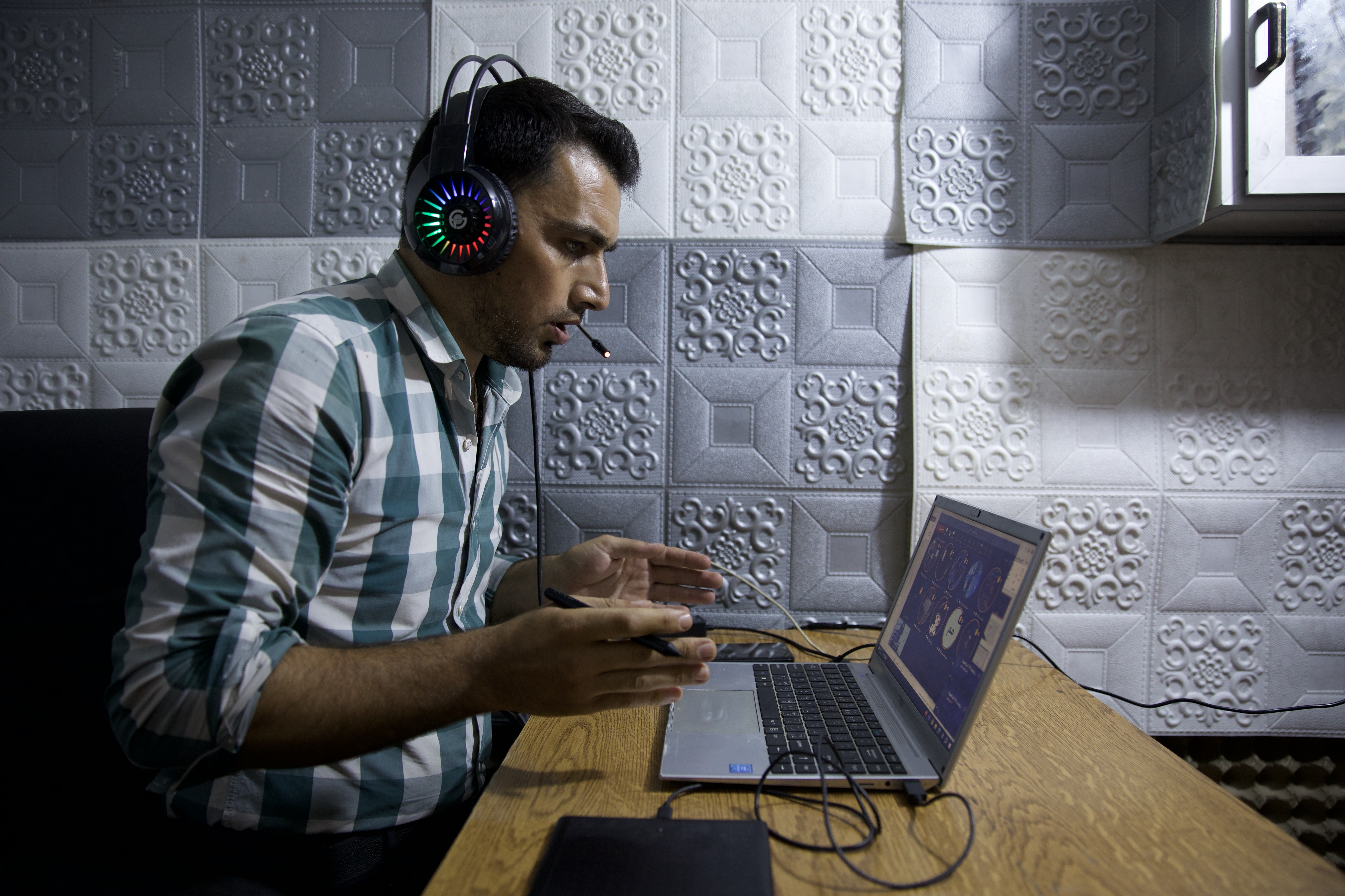 a man at a laptop delivers a lesson