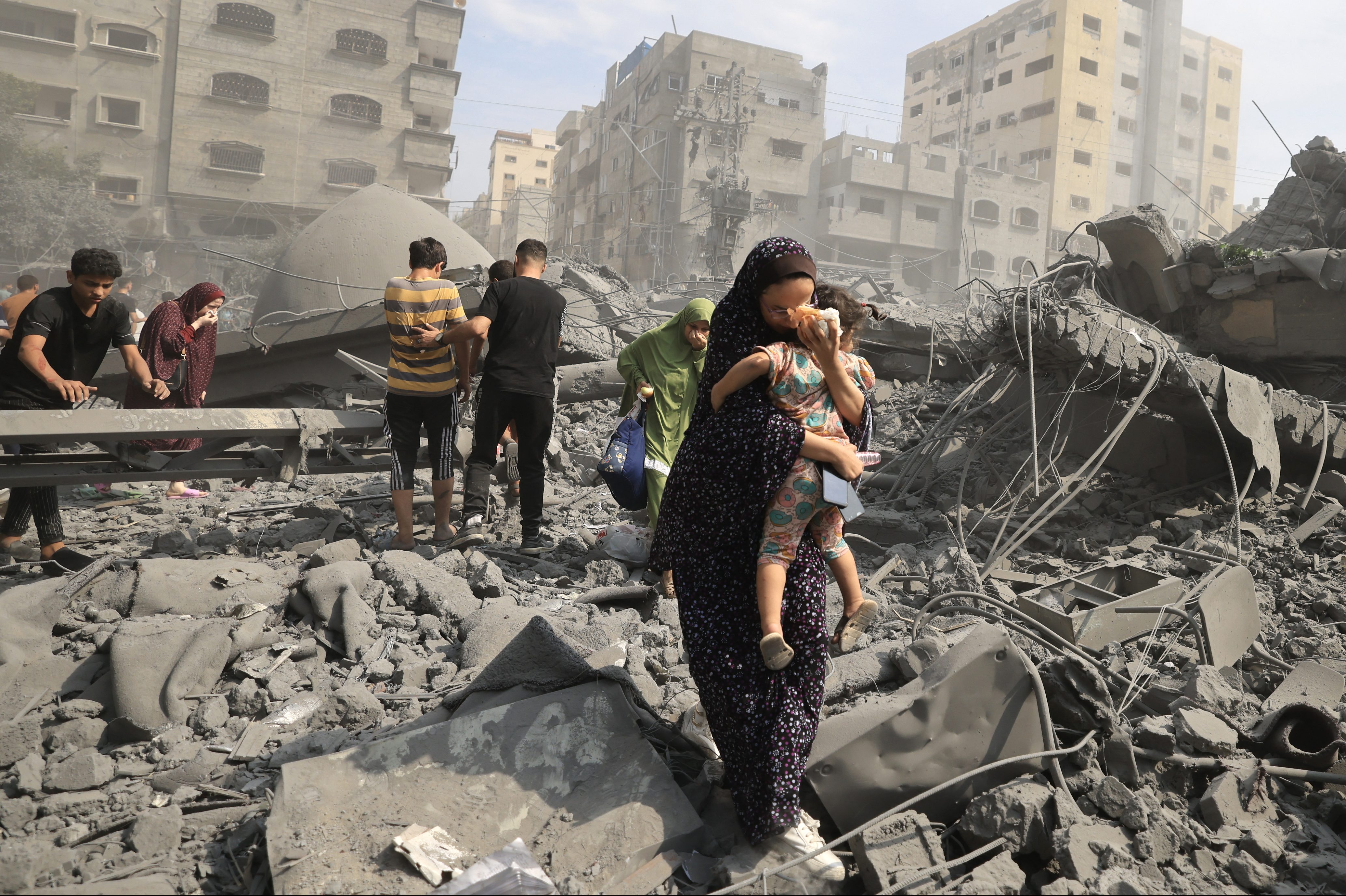 Palestinians evacuate the area following an Israeli airstrike on the Sousi mosque in Gaza City