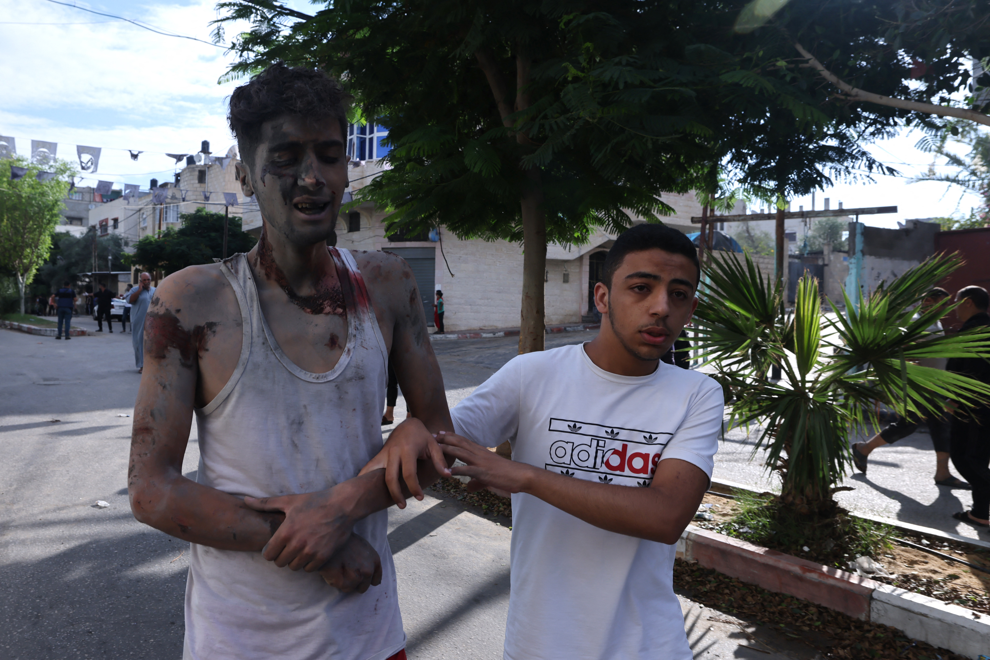 Palestinians evacuate a wounded civilian after an Israeli airstrike at the Rafah refugee camp