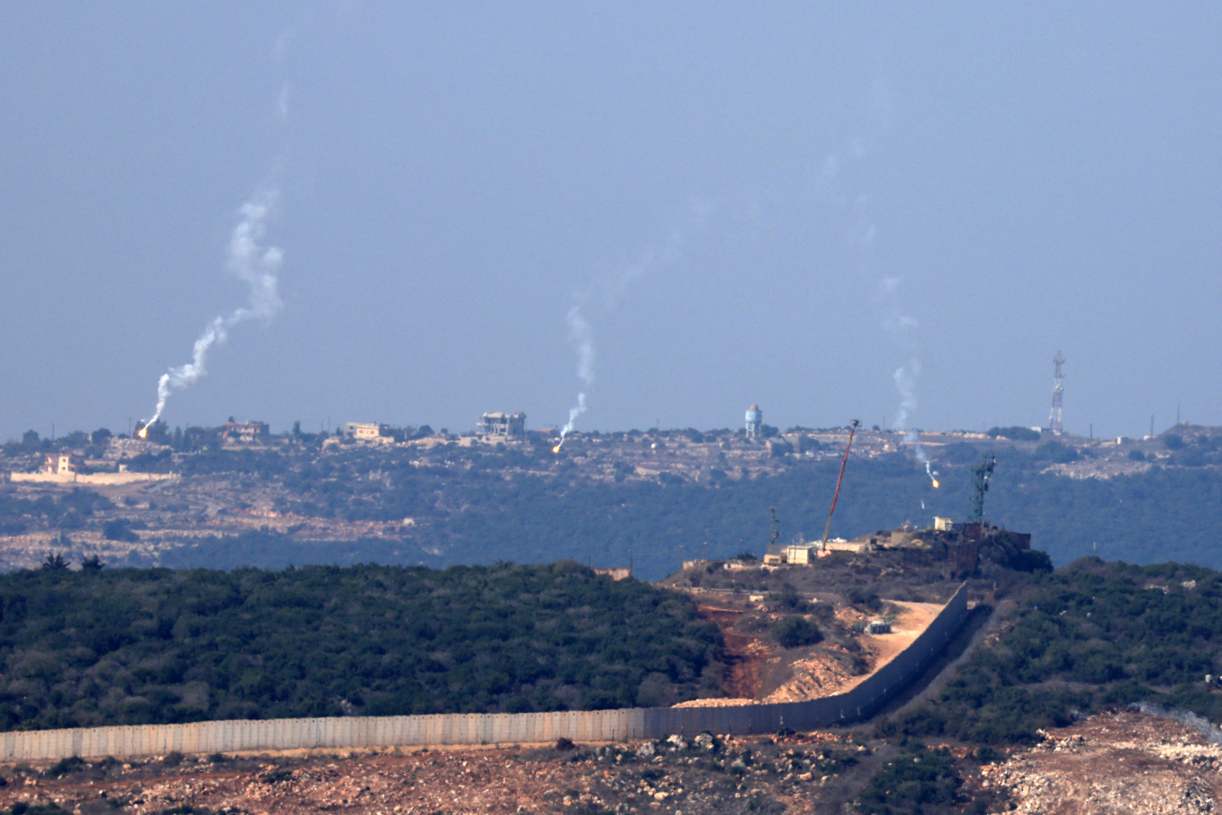 Flares are fired from northern Israel over the southern Lebanese border village of Aita al-Shaab