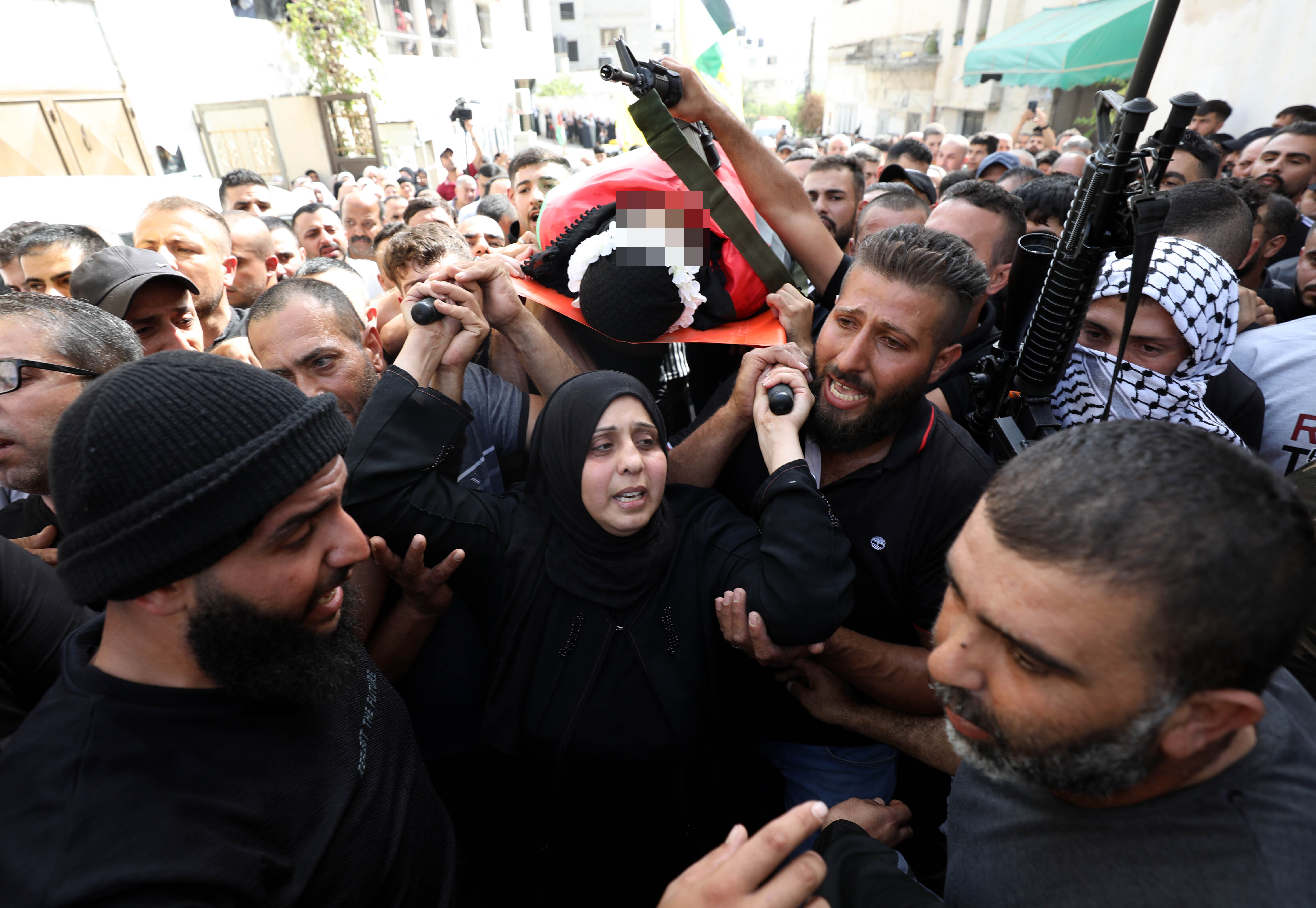 Dunya leading the pallbearers for her son