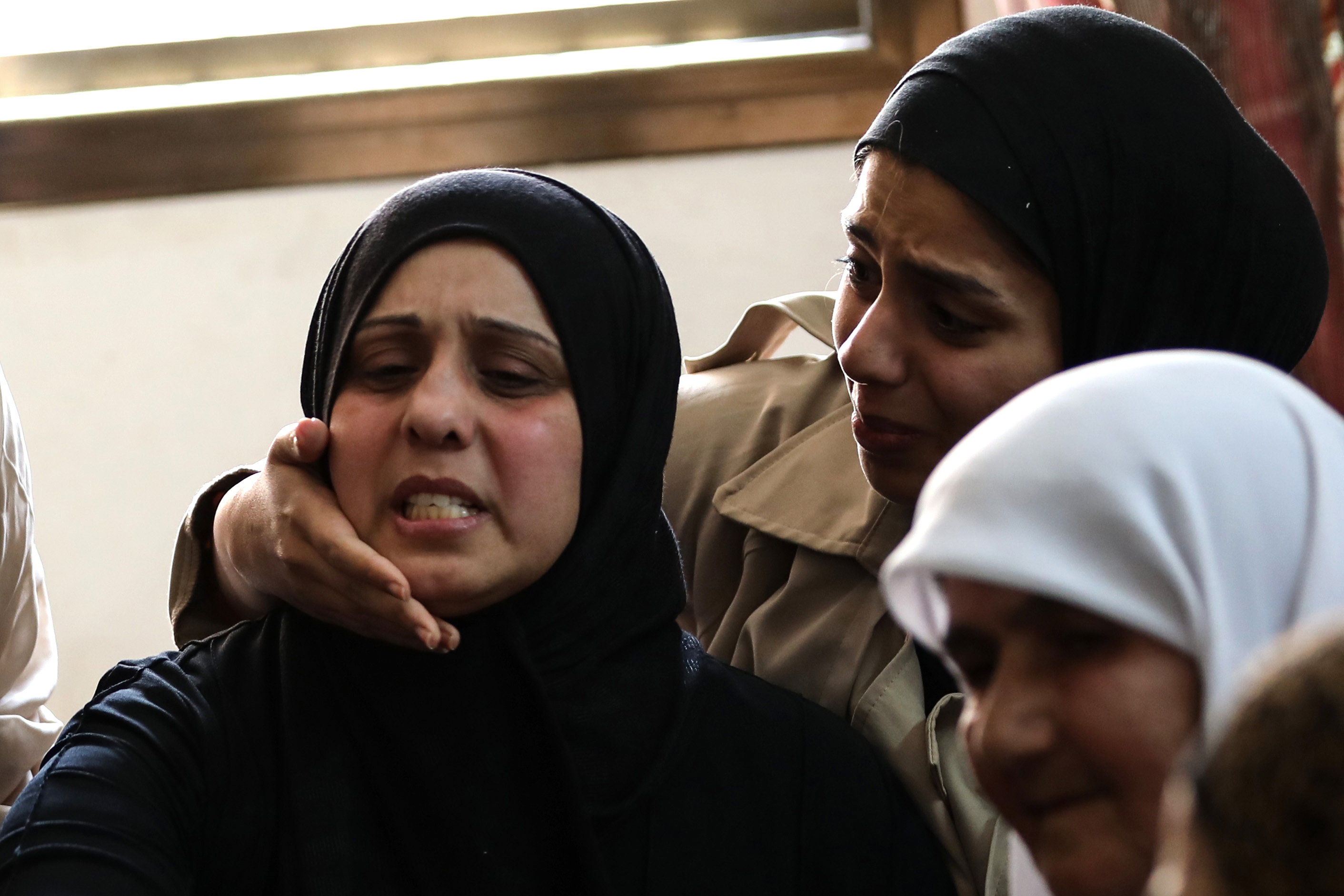 Dunya Ghanem being consoled
