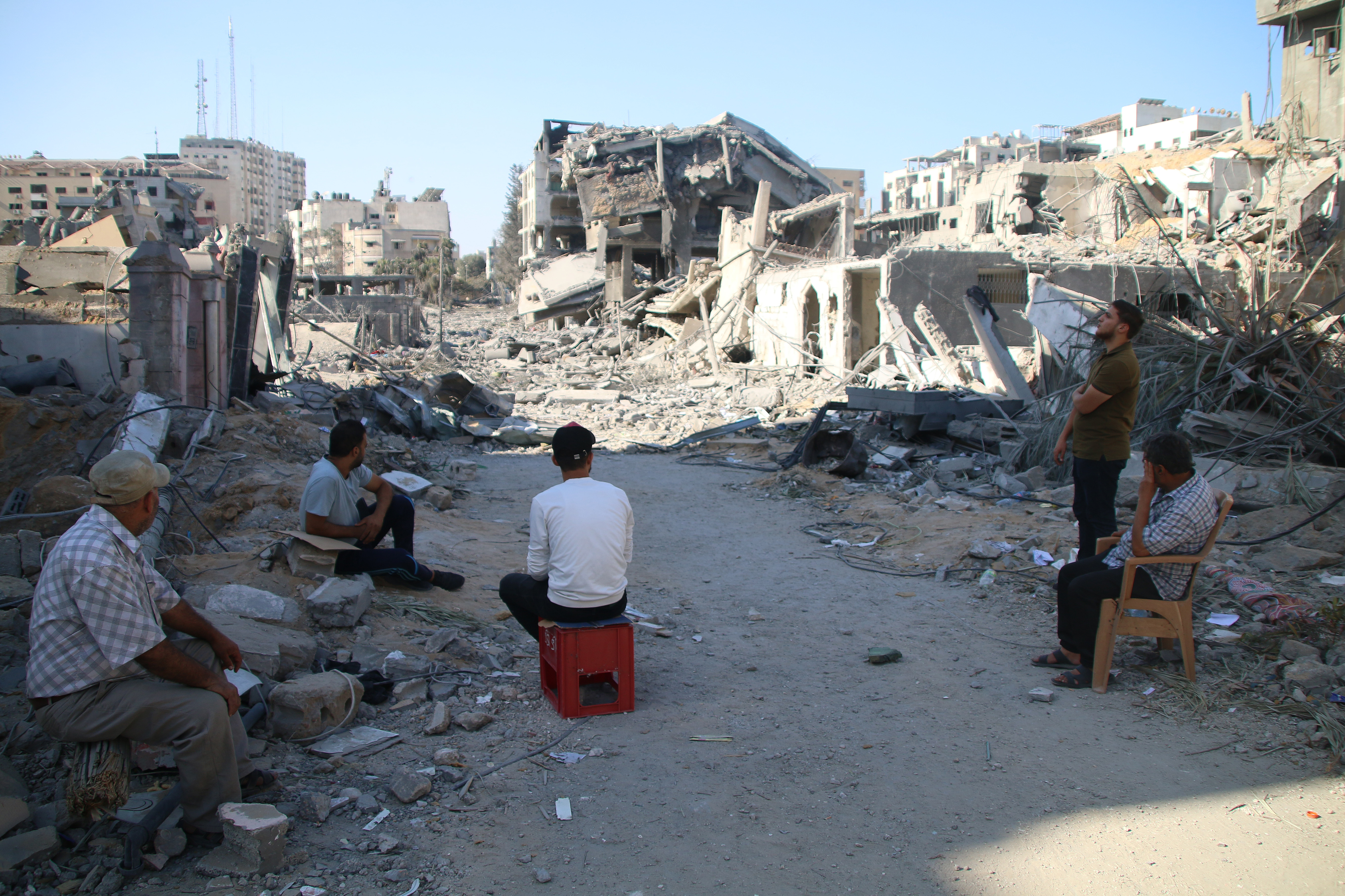 Palestinian citizens inspect damage to their homes caused by Israeli airstrikes