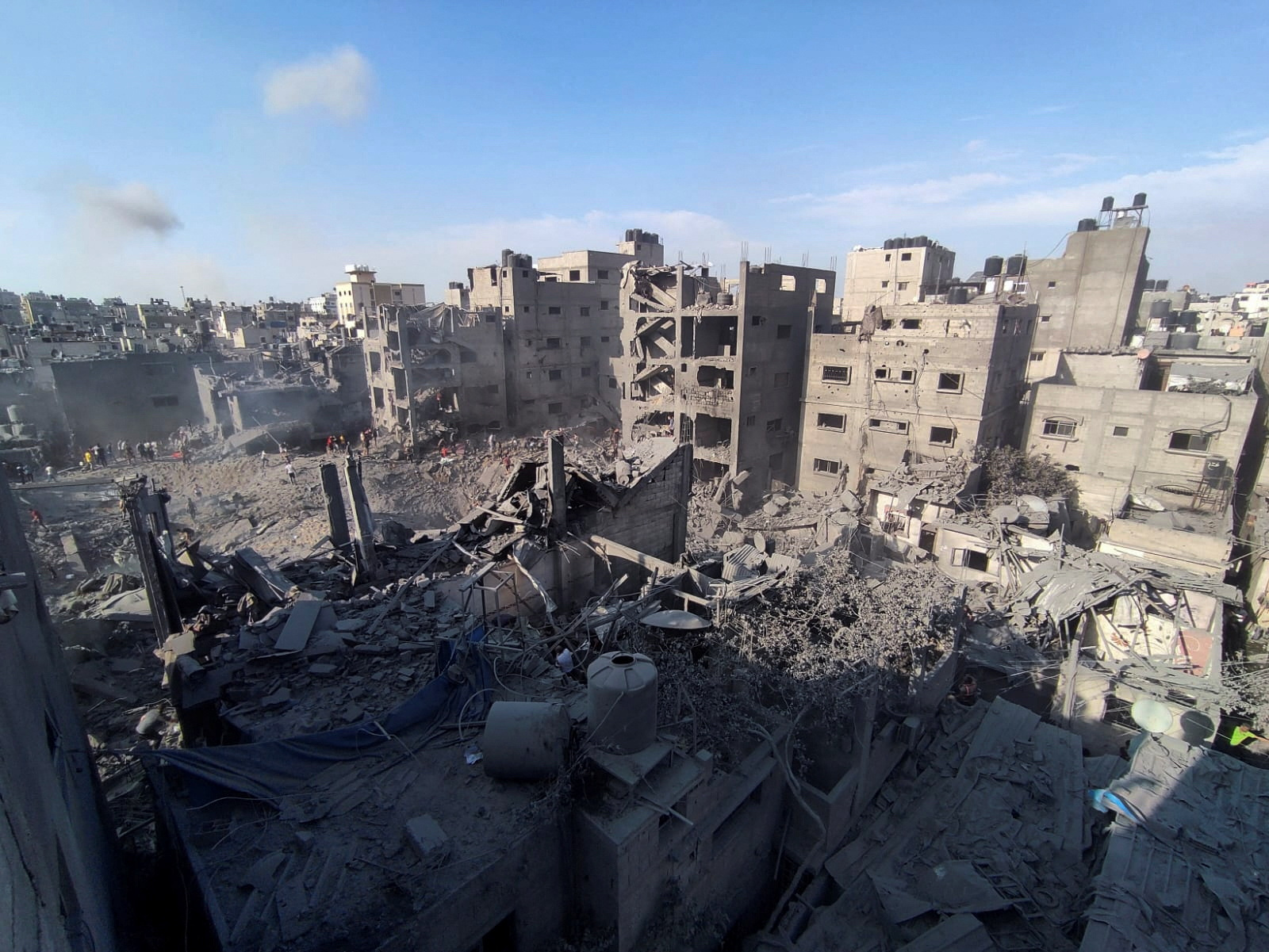 Palestinians search for casualties at the site of Israeli strikes on houses in Jabalia refugee camp