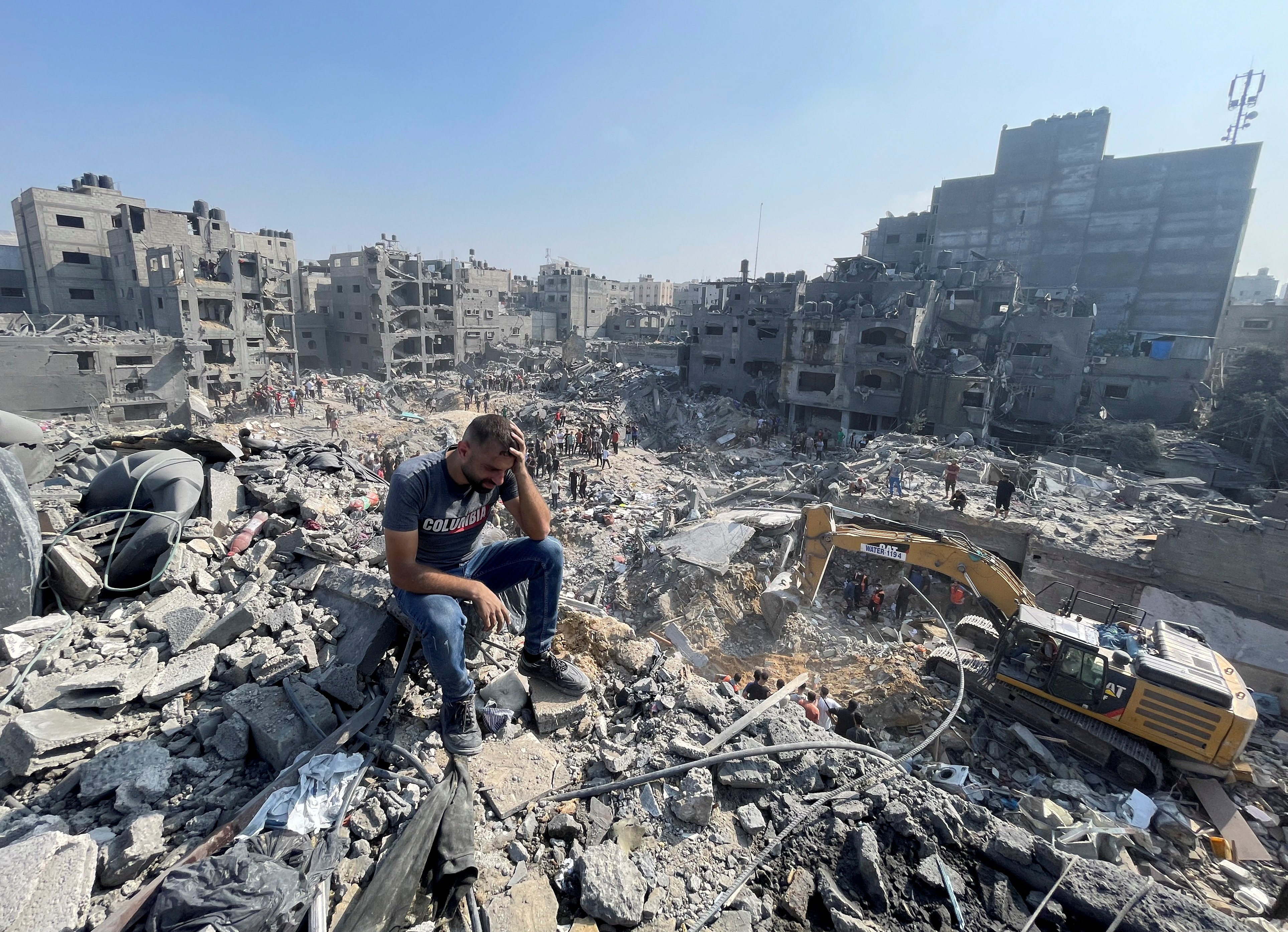 A man gestures as Palestinians search for casualties a day after Israeli strikes on houses in Jabalia refugee camp in the northern Gaza Strip.