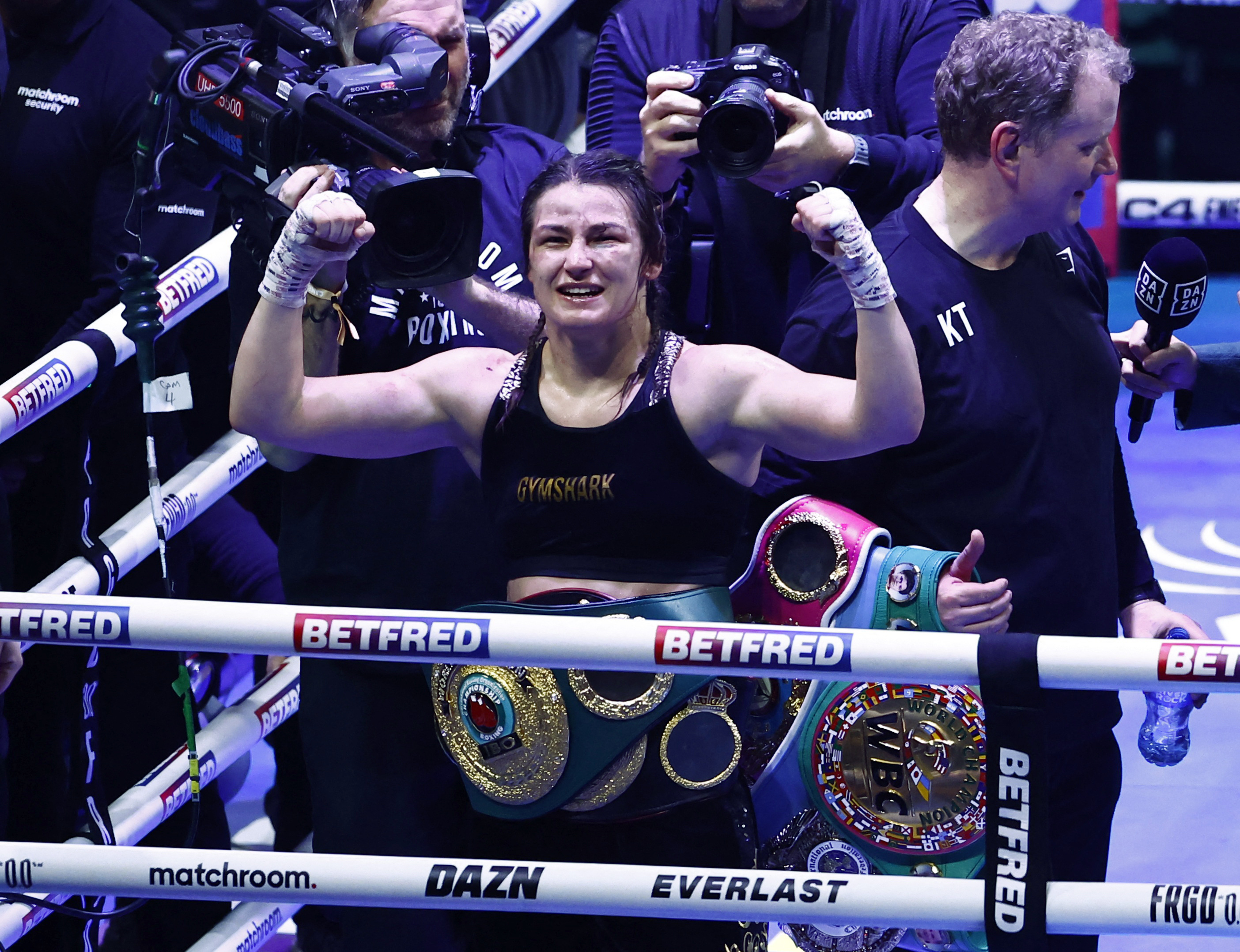 Boxing - Chantelle Cameron v Katie Taylor - IBF, IBO, WBA, WBC & WBO World Super Lightweight Titles - 3Arena, Dublin, Ireland - November 25, 2023 Katie Taylor celebrates with her belts after winning her fight against Chantelle Cameron REUTERS/Clodagh Kilcoyne