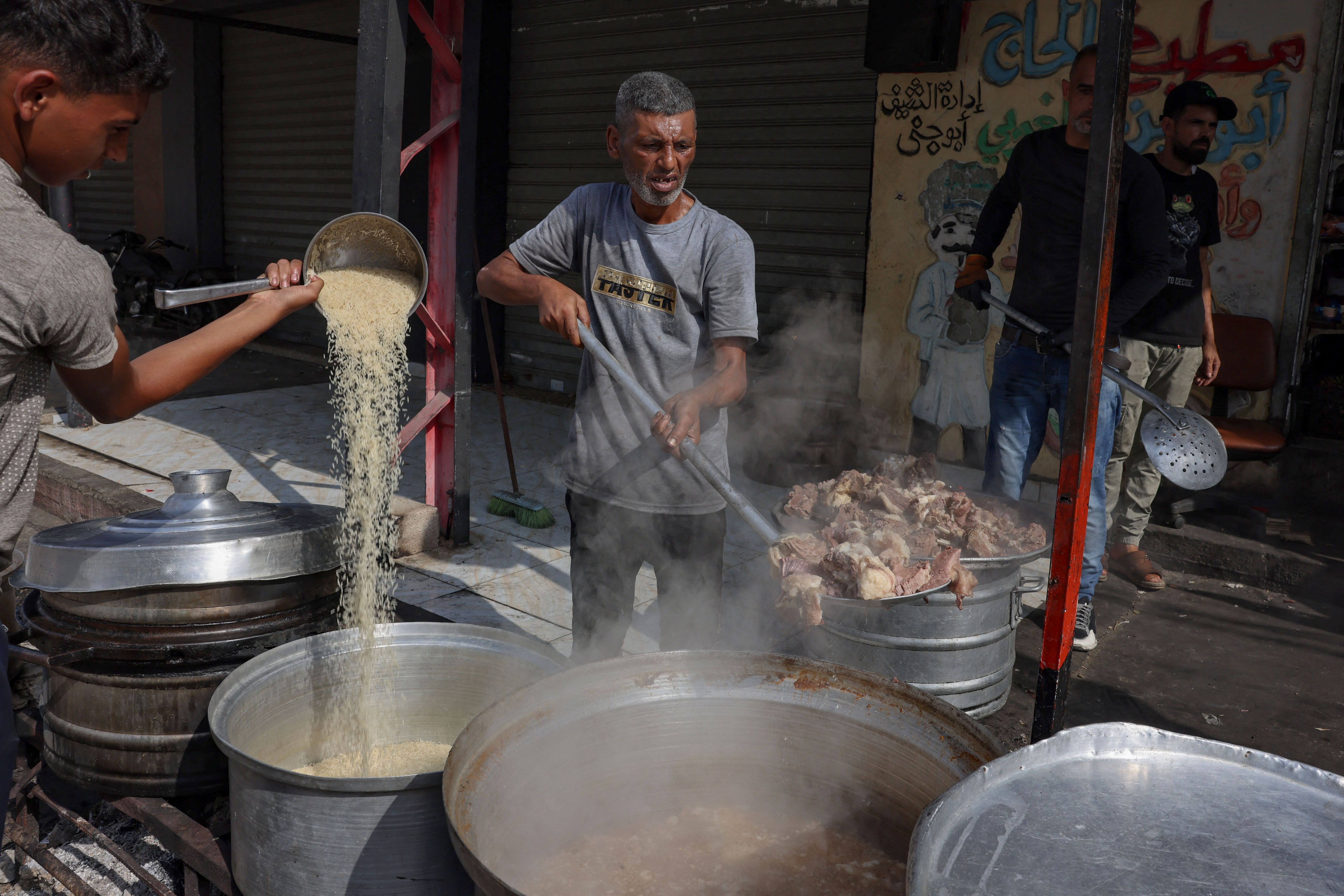 Palestinians cook in a street in Rafah in the southern Gaza Strip, on November 8, 2023, amid the ongoing battles between Israel and Hamas.