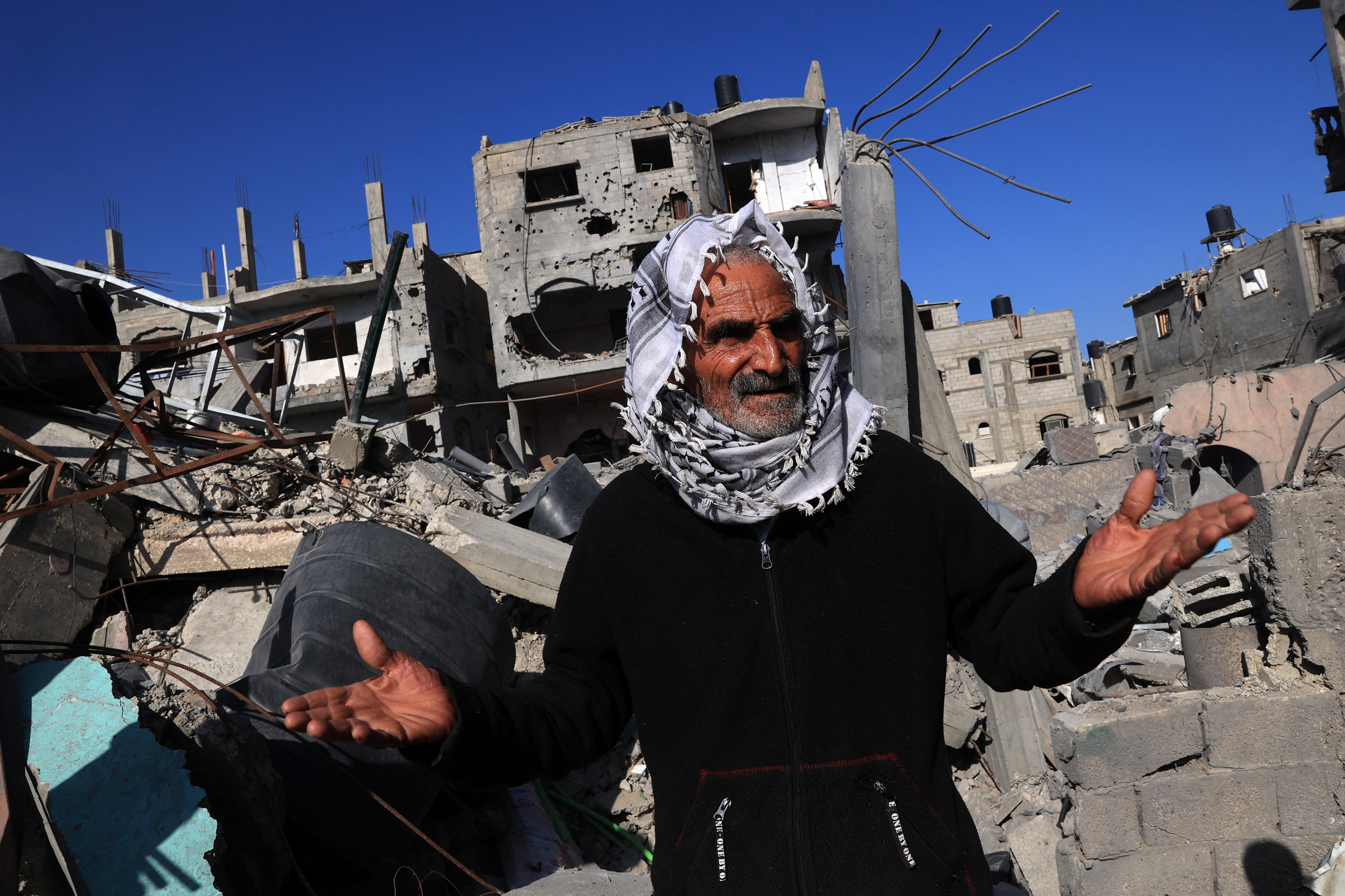 Amal al-Robayaa's father Salman stands in front of the family home destroyed in an Israeli strike in Rafah