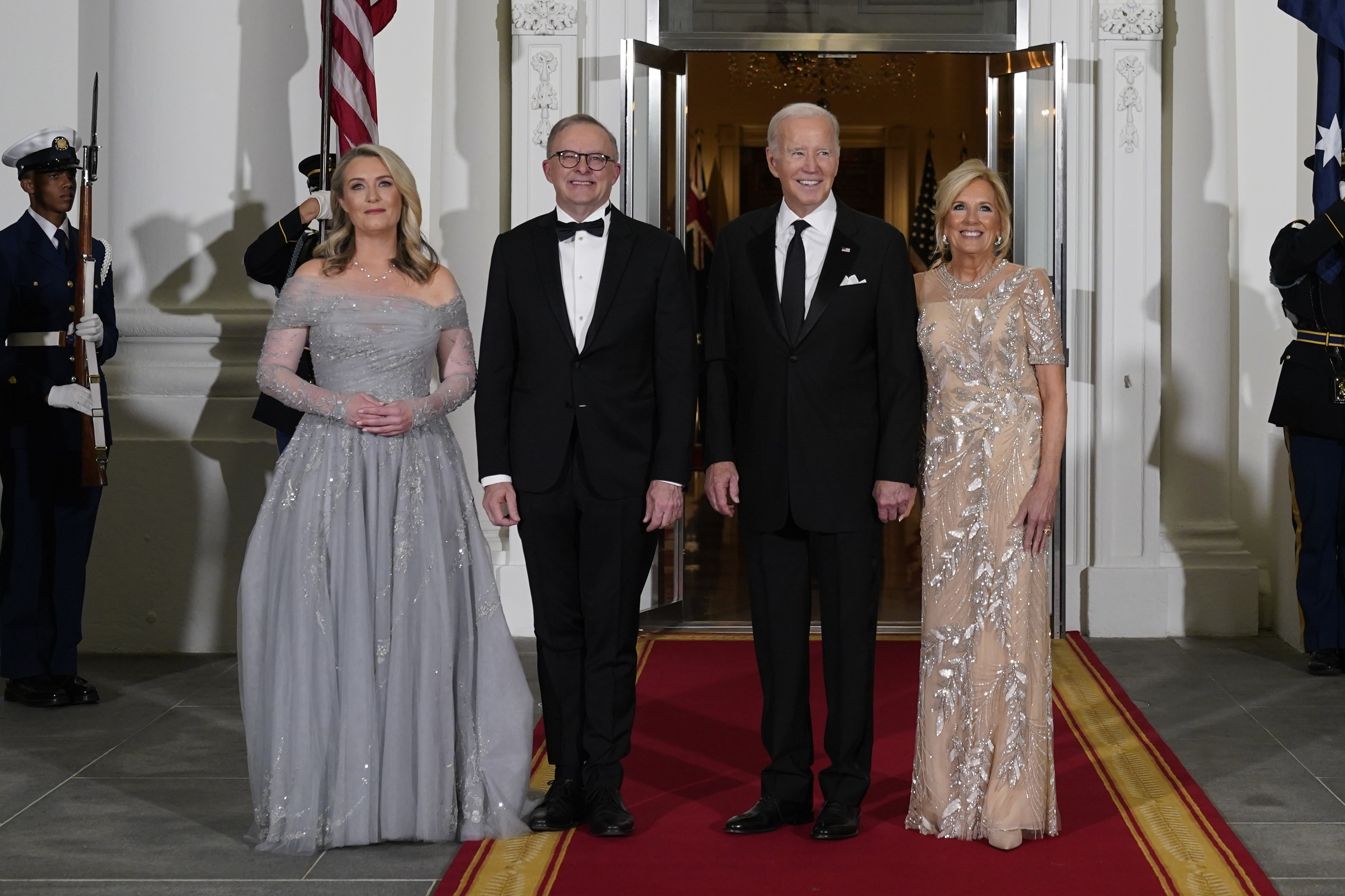 President Joe Biden and first lady Jill Biden welcome Australian Prime Minister Anthony Albanese and his partner Jodie Haydon at the White House. They're wearing evening dress.