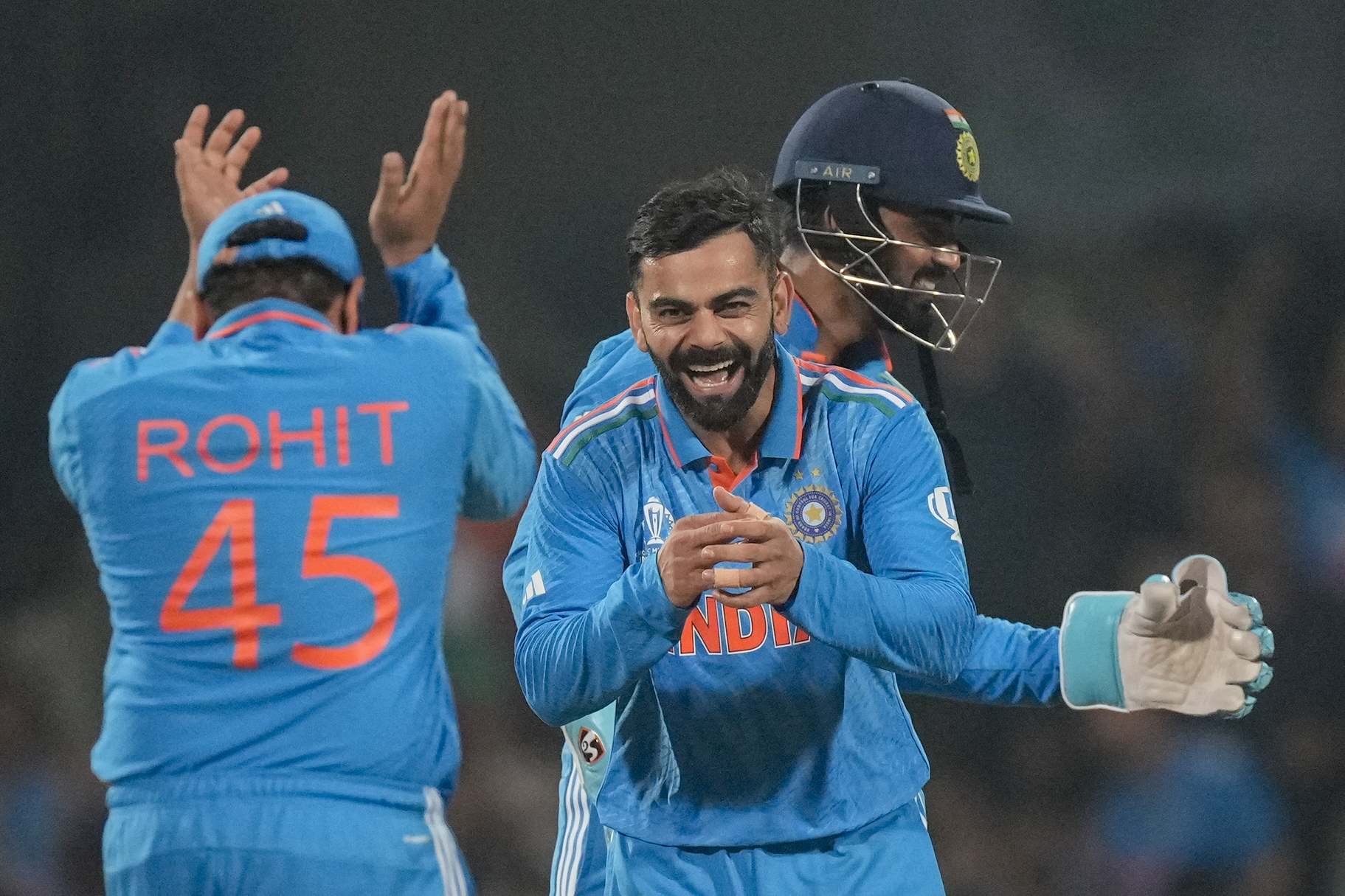 India's Virat Kohli, centre, celebrates the wicket of Netherlands' captain Scott Edwards during the ICC Men's Cricket World Cup match between India and Netherlands in Bengaluru, India, Sunday, Nov. 12, 2023. (AP Photo/Anupam Nath)