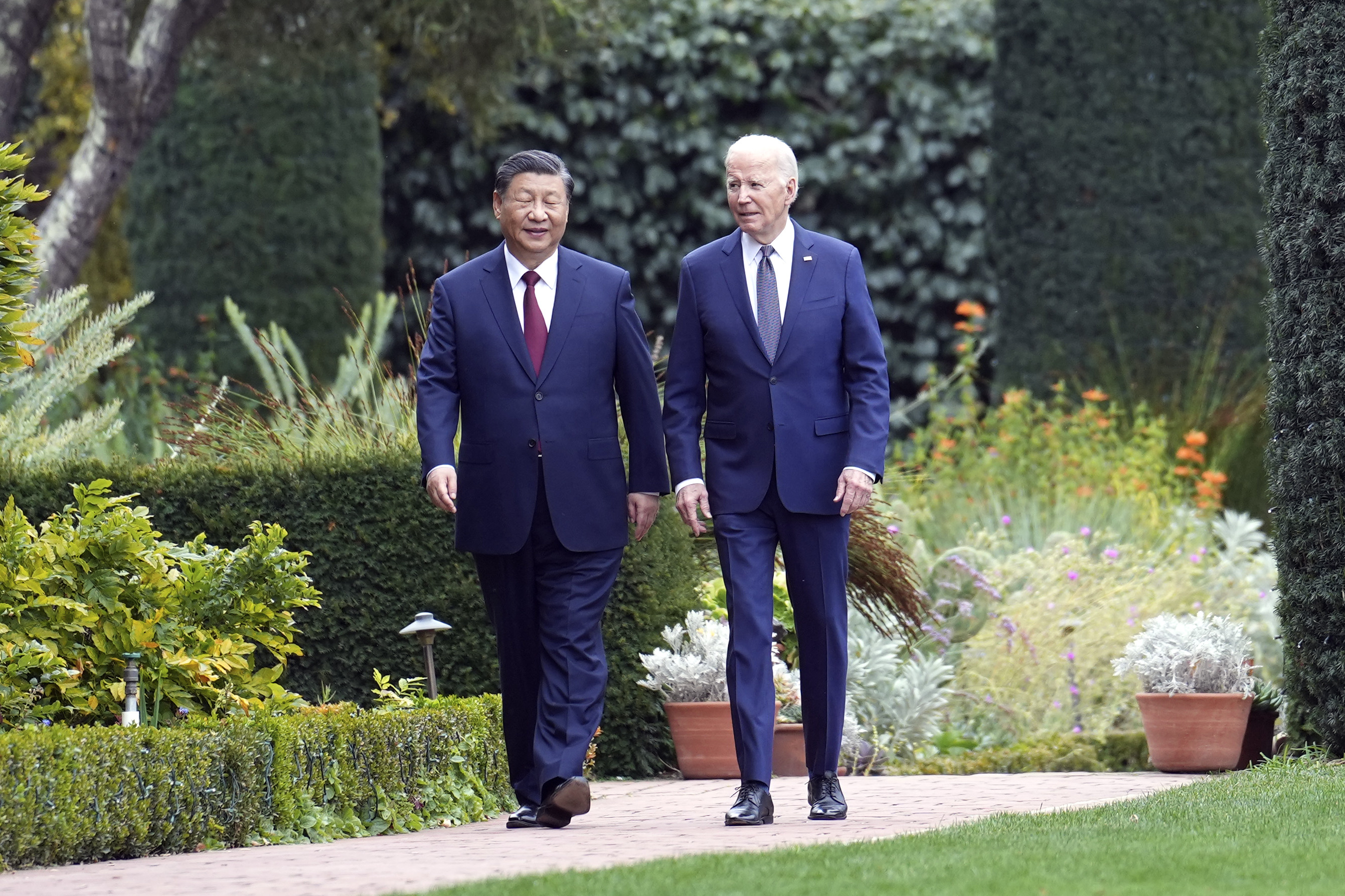 Xi and Biden walking in the gardens of the Filoli Estate. They look relaxed.