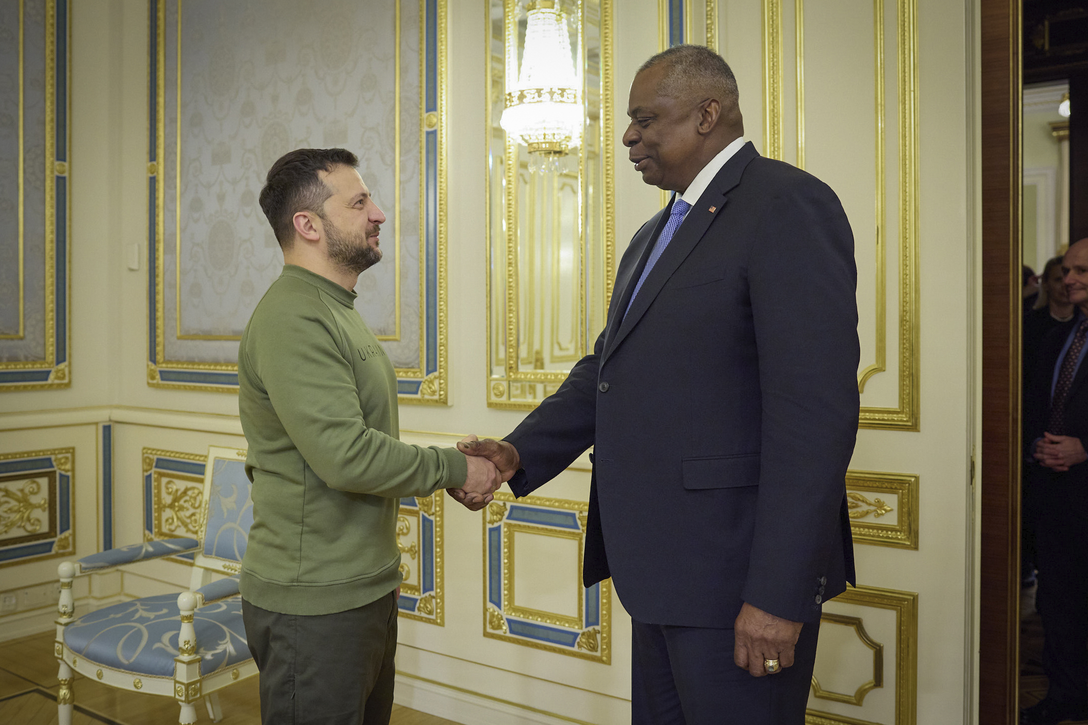 Ukrainian President Volodymyr Zelenskyy, left, shakes hands with U.S. Secretary of Defense Lloyd Austin in Kyiv