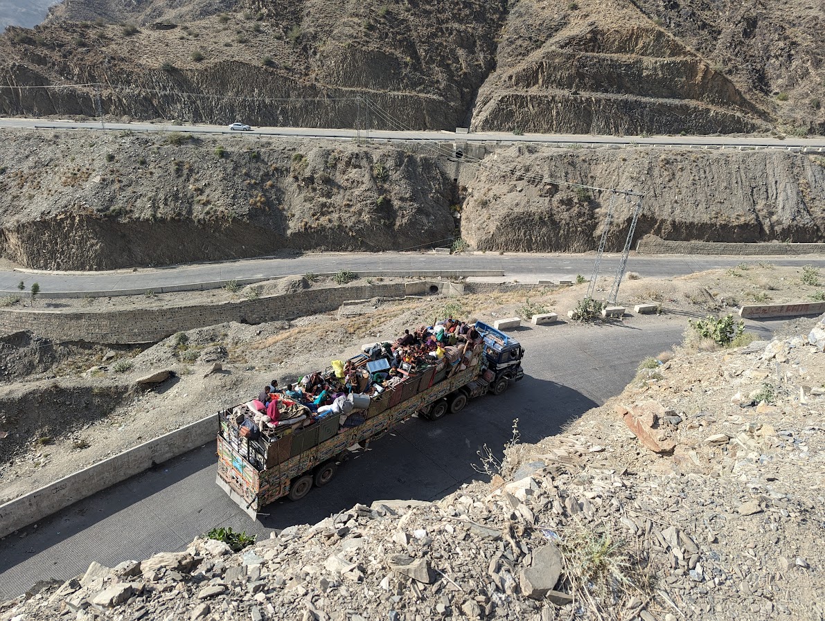 An Afghan family with its belongings traveling in a container passing from the Khyber pass towards Torkham border crossing-1699011855
