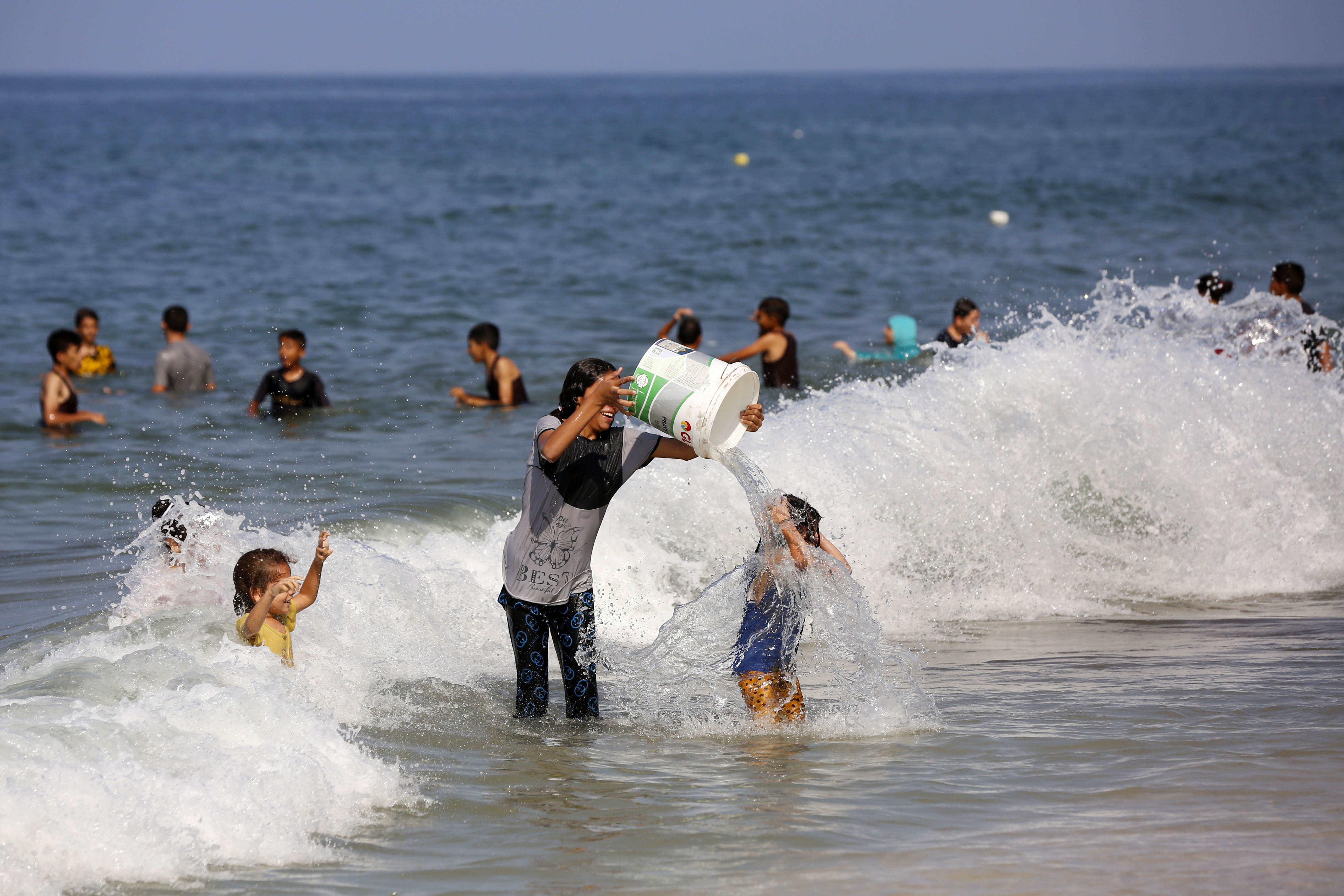Palestinians using the sea to wash their clothes and bathe