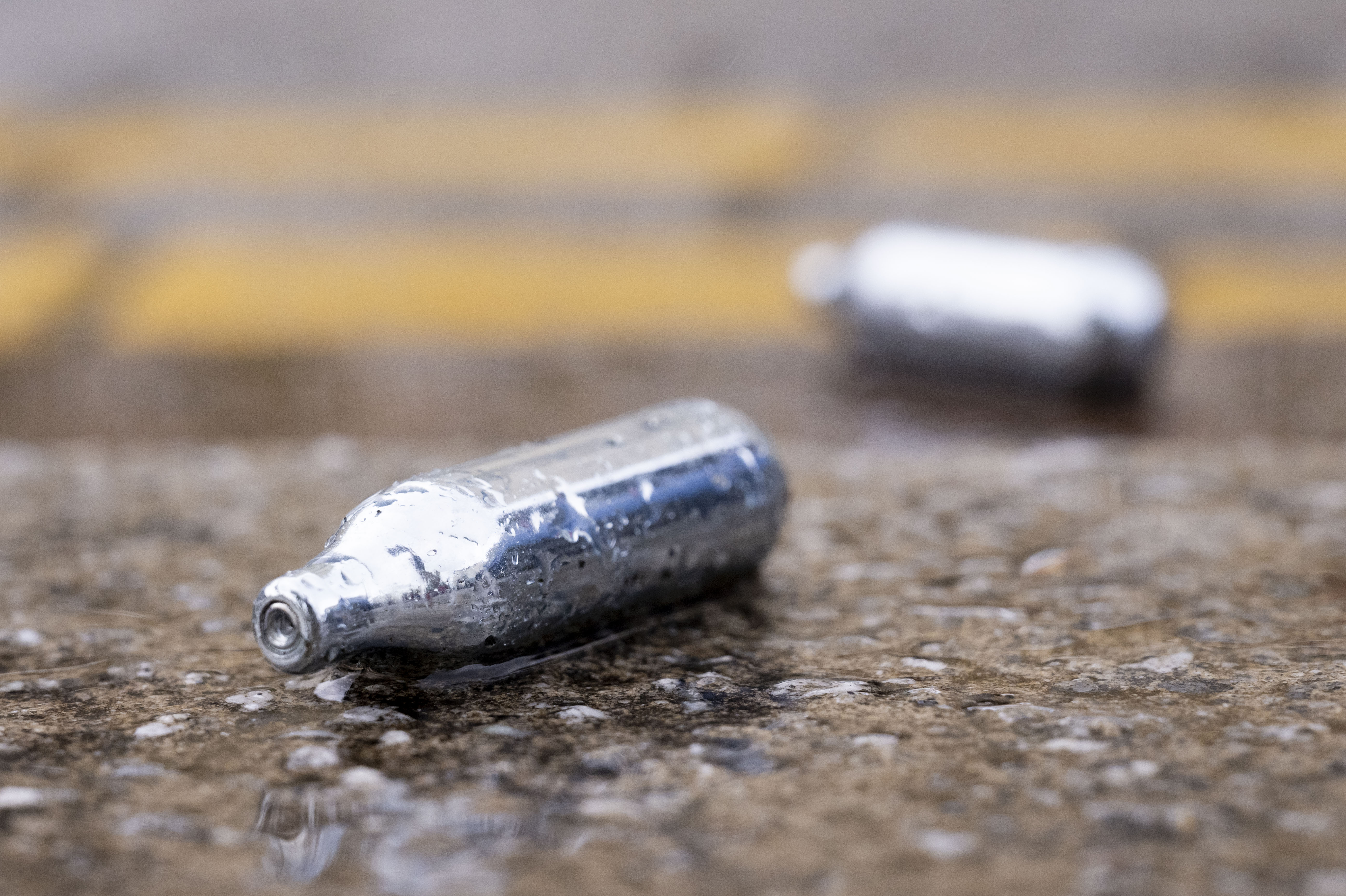 Used metal canisters of nitrous oxide