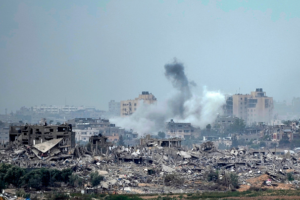 In this photograph taken near the Israeli border with the Gaza Strip, a plume of smoke rises over Beit Hanoun in Northern Gaza after an Israeli air strike on November 22, 2023 in Sederot, Israel.