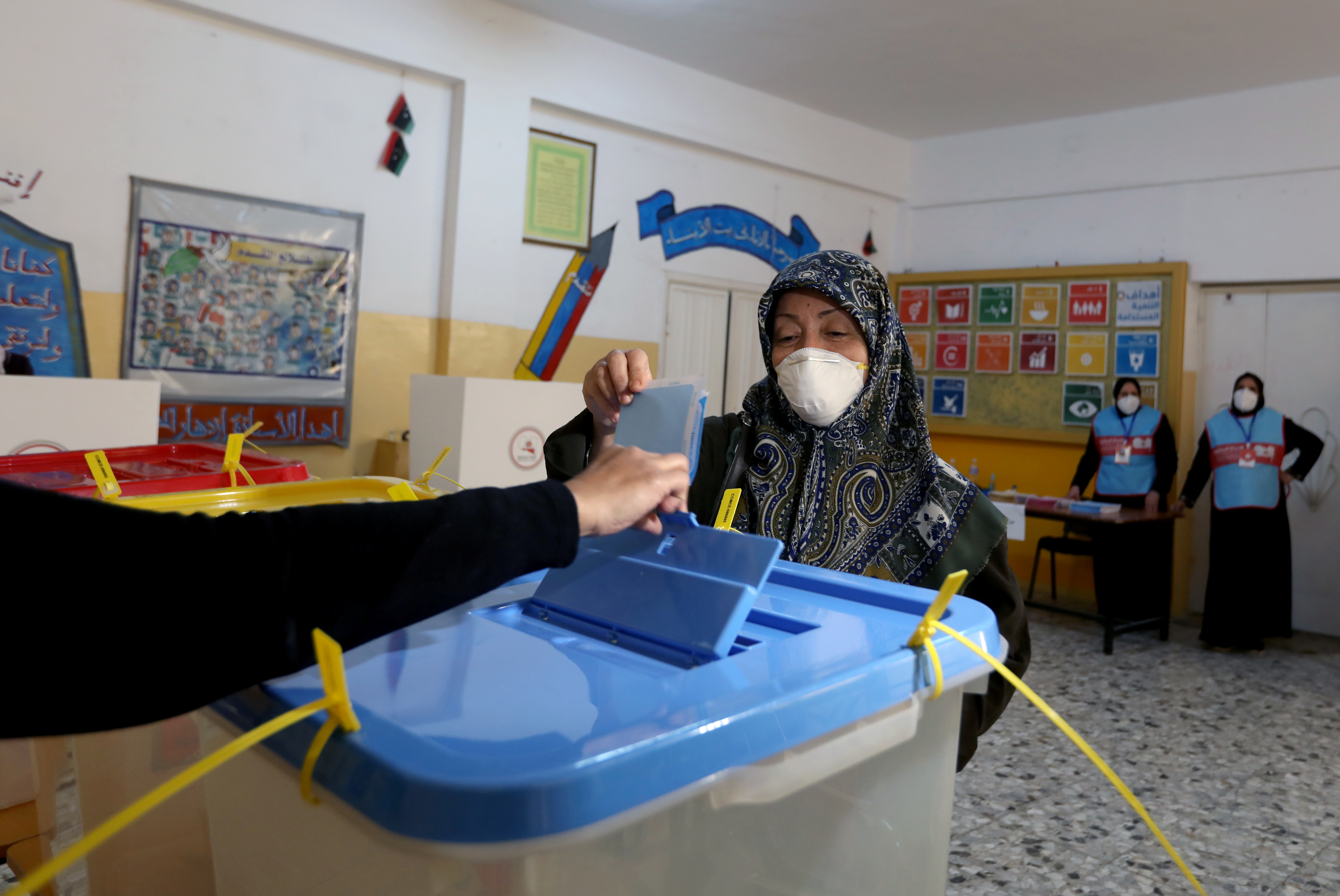 A woman votes at municipal elections in Libya 2021