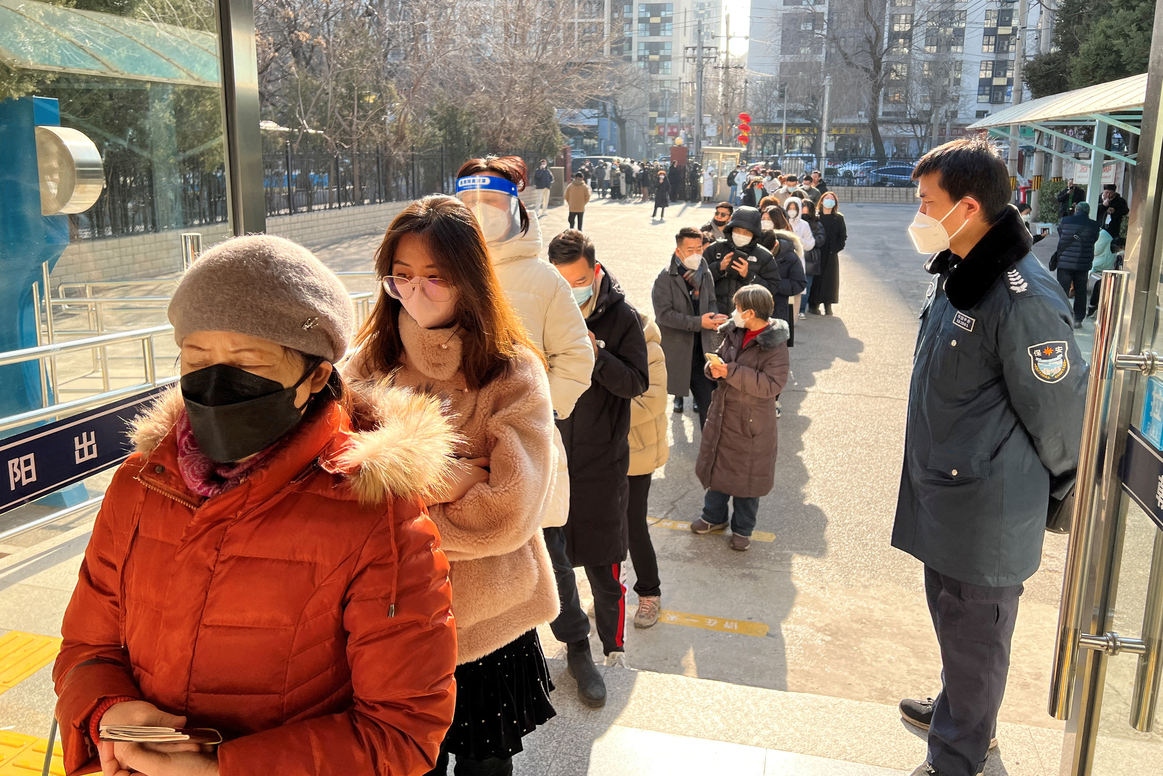 People line up at a government office for entry and exit matters which provides services including making or renewing passports or permits to go to Hong Kong, Macau and Taiwan, after China reopened borders, in Beijing, China January 9