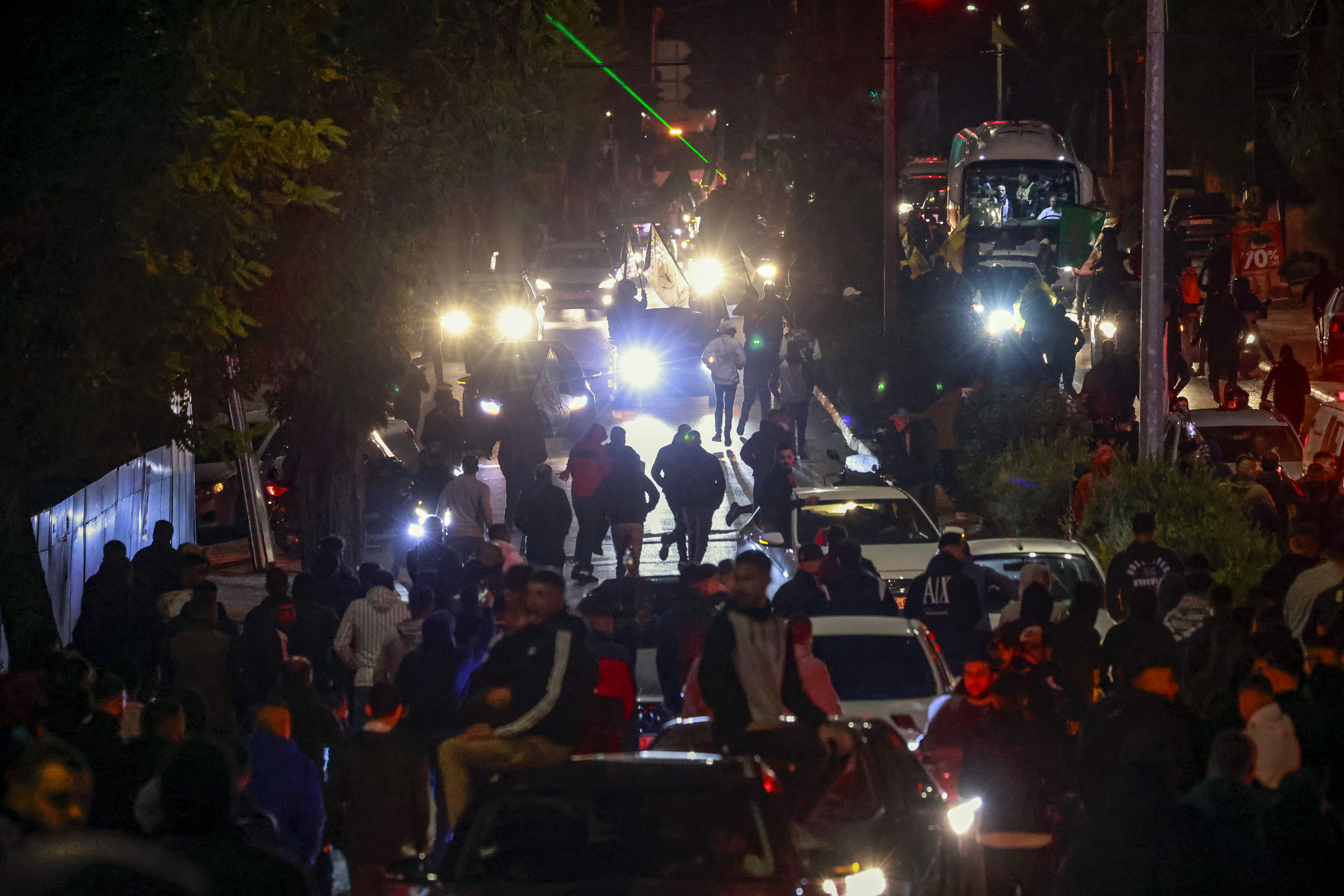 A Red Cross bus arrives amid supporters during a welcome ceremony following the release of Palestinian prisoners from Israeli jails.