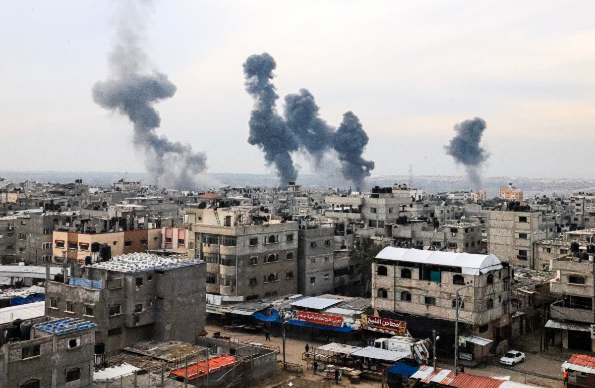 A picture taken on December 20, 2023, from Rafah shows smoke billowing after Israeli strikes over the Nuseirat refugee camp in the central Gaza Strip, amid ongoing battles between Israel and the militant group Hamas.