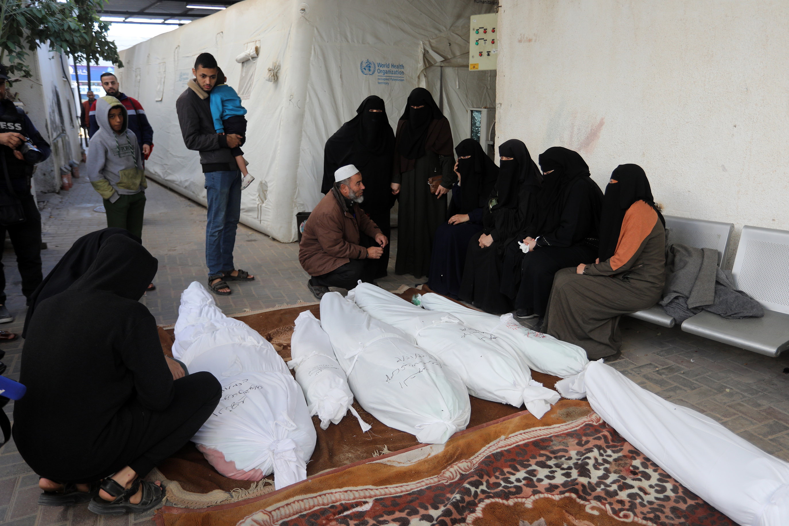 Relatives of Palestinians, died in the Israeli airstrikes, mourn as they take the body from the morgue of En Neccar Hospital for the funeral ceremony in Rafah, Gaza on December 03