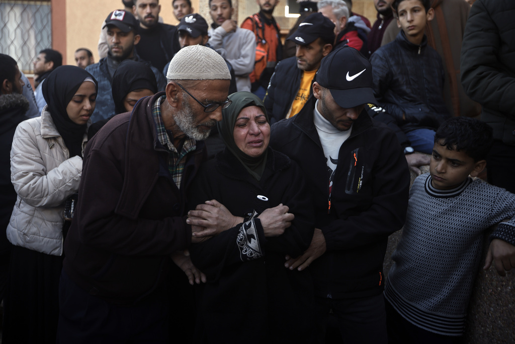 Palestinians mourn relatives killed in an Israeli airstrike