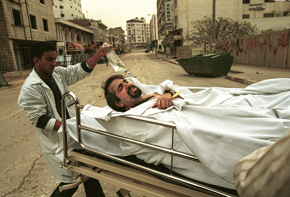 A photo of Palestinian paramedics provide medical care for Boston Globe reporter Anthony Shadid.