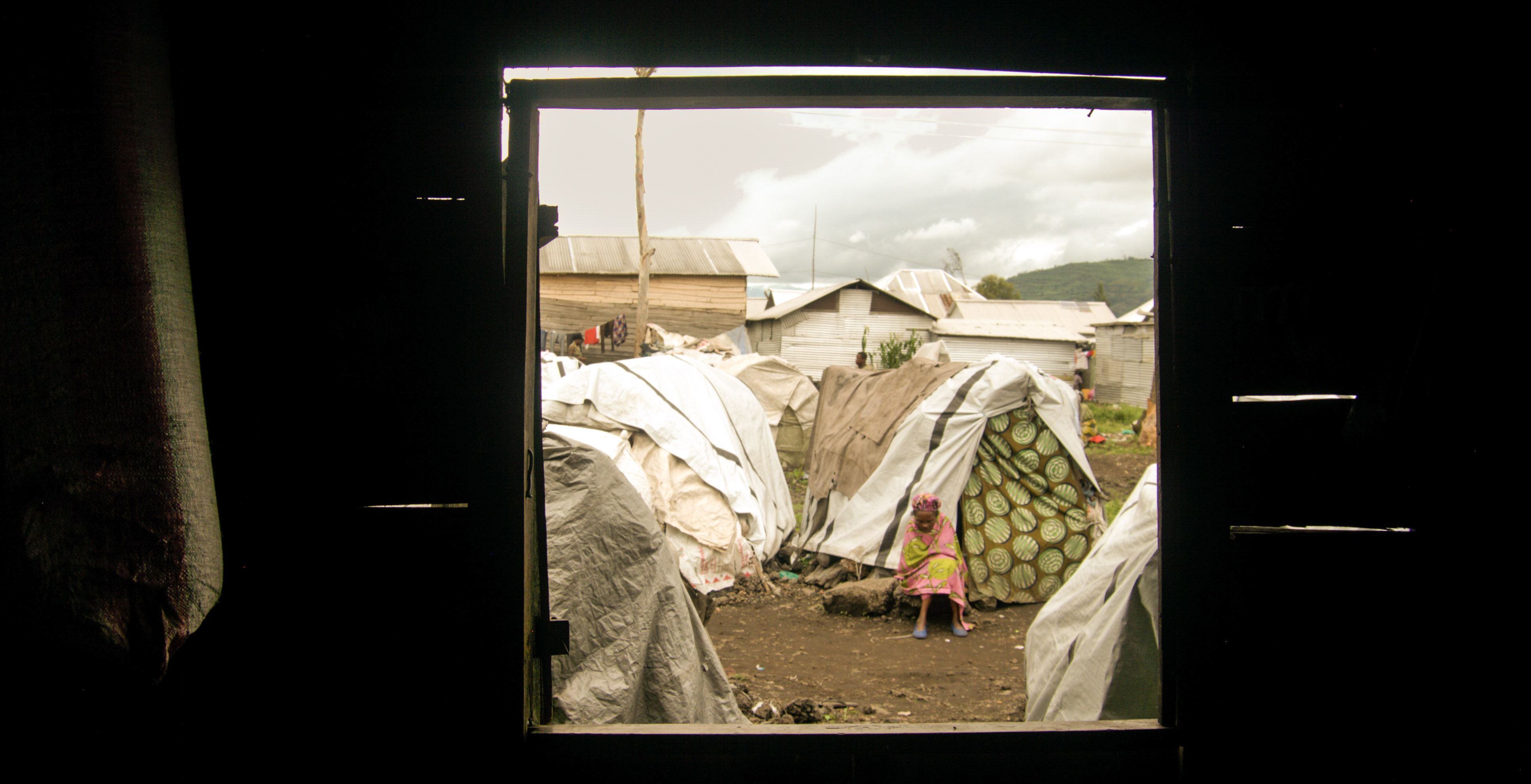 A displaced woman rests outside her tent in Kanyaruchinya camp in eastern Congo