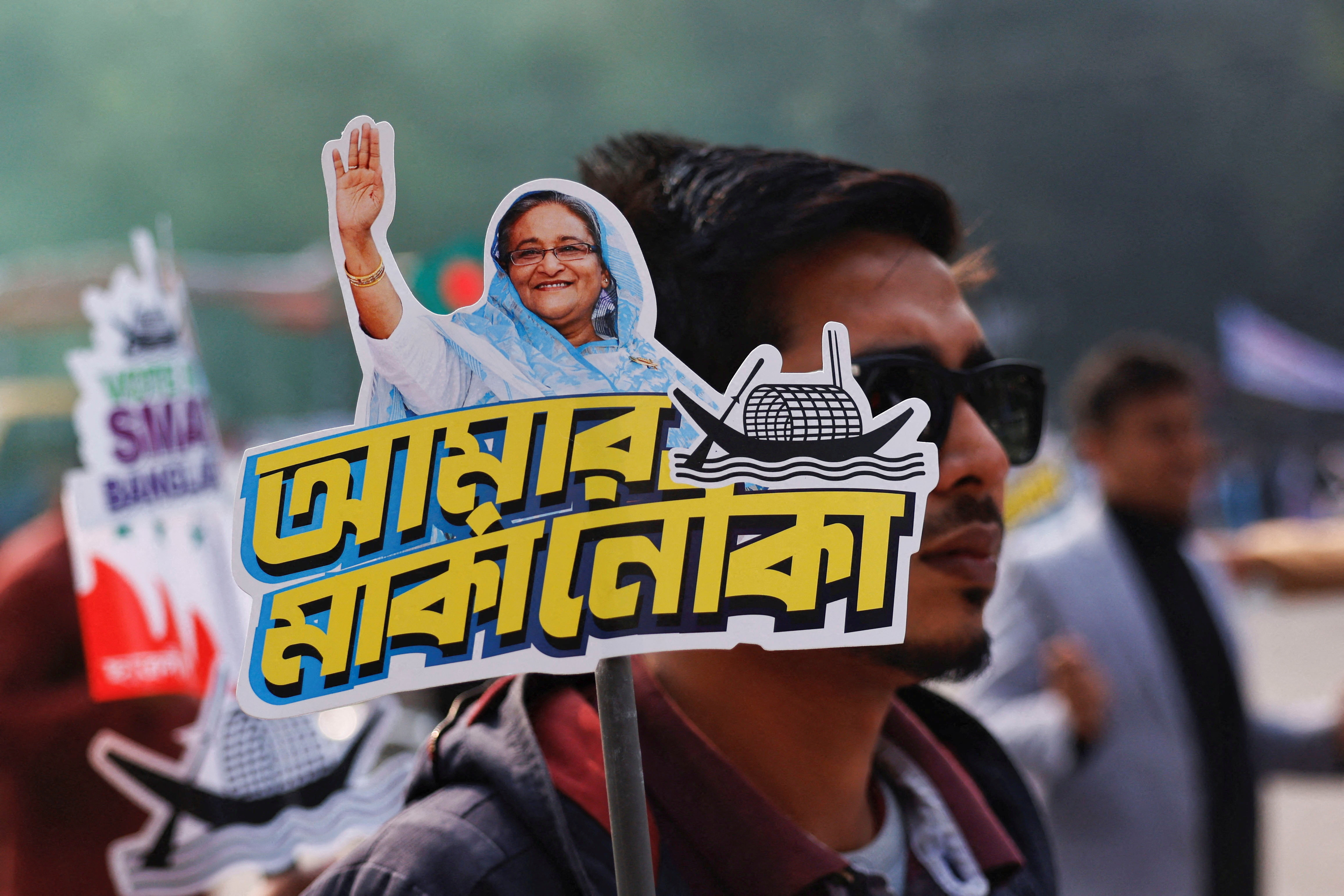 A student holds a placard of Prime Minister Sheikh Hasina as they celebrate the formation day of Bangladesh Chhatra League, the student wing of Bangladesh Awami League, at the University of Dhaka, ahead of the general election in Dhaka, Bangladesh, January 4, 2024