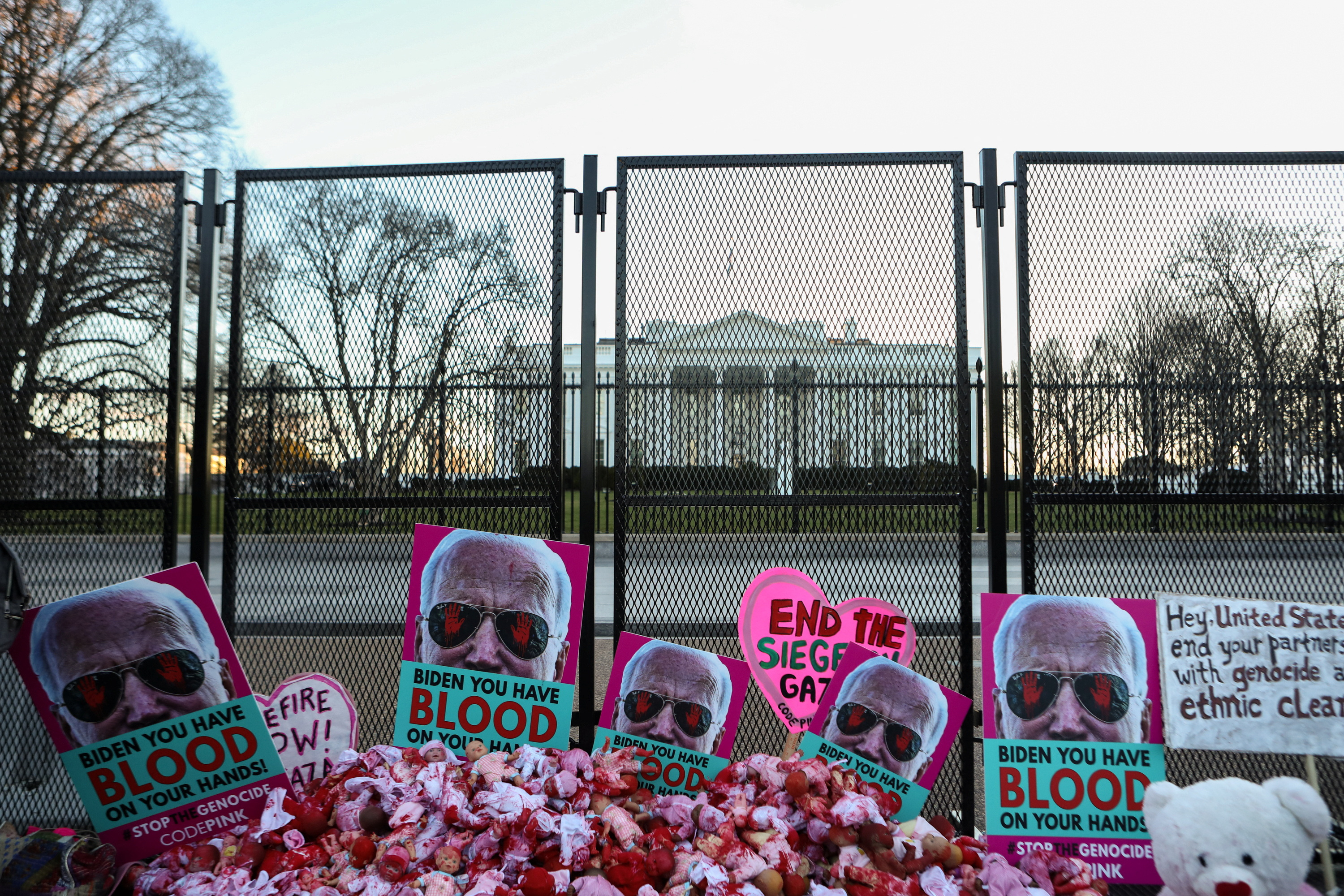 Posters of Biden at a fence outside the White House, urging him to demand a ceasefire in Gaza