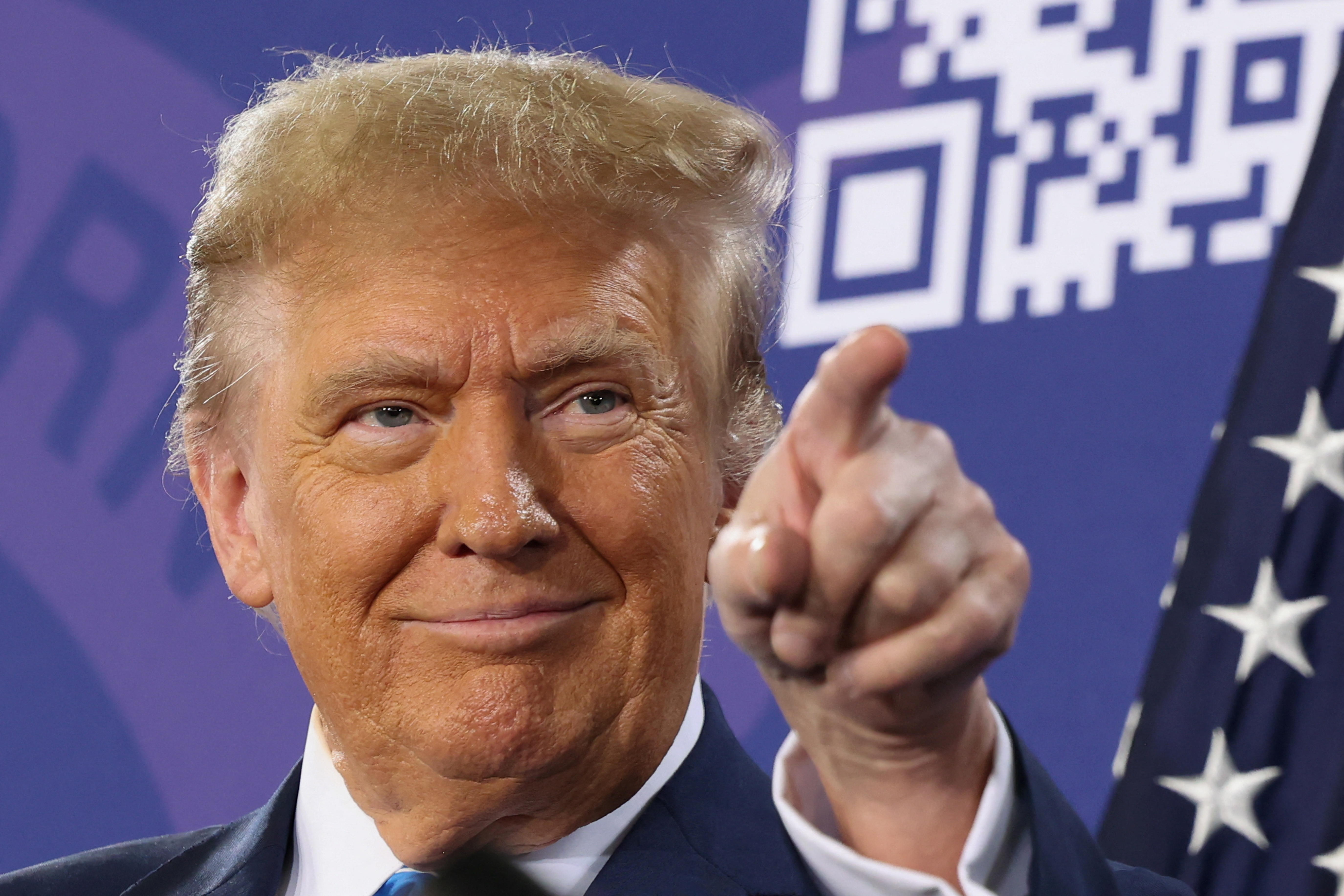 Donald Trump points at a crowd