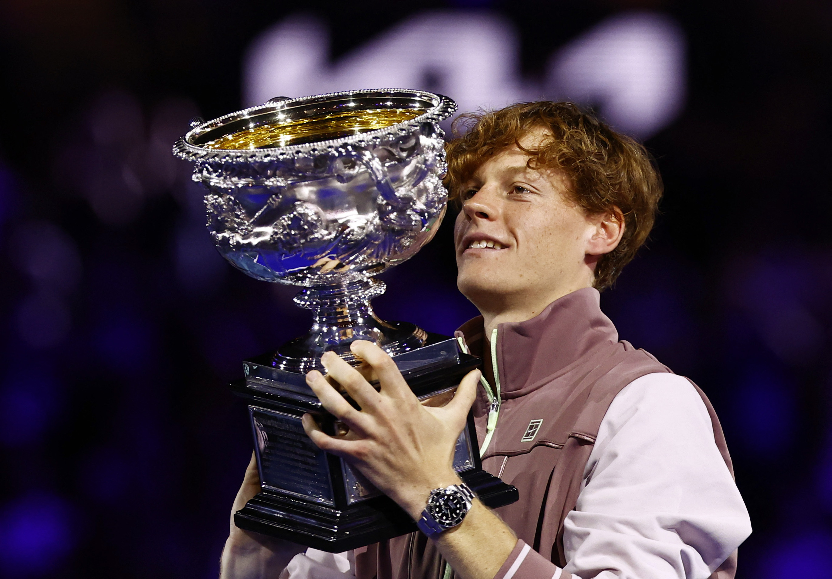 Italy's Jannik Sinner celebrates with the trophy after winning the final.