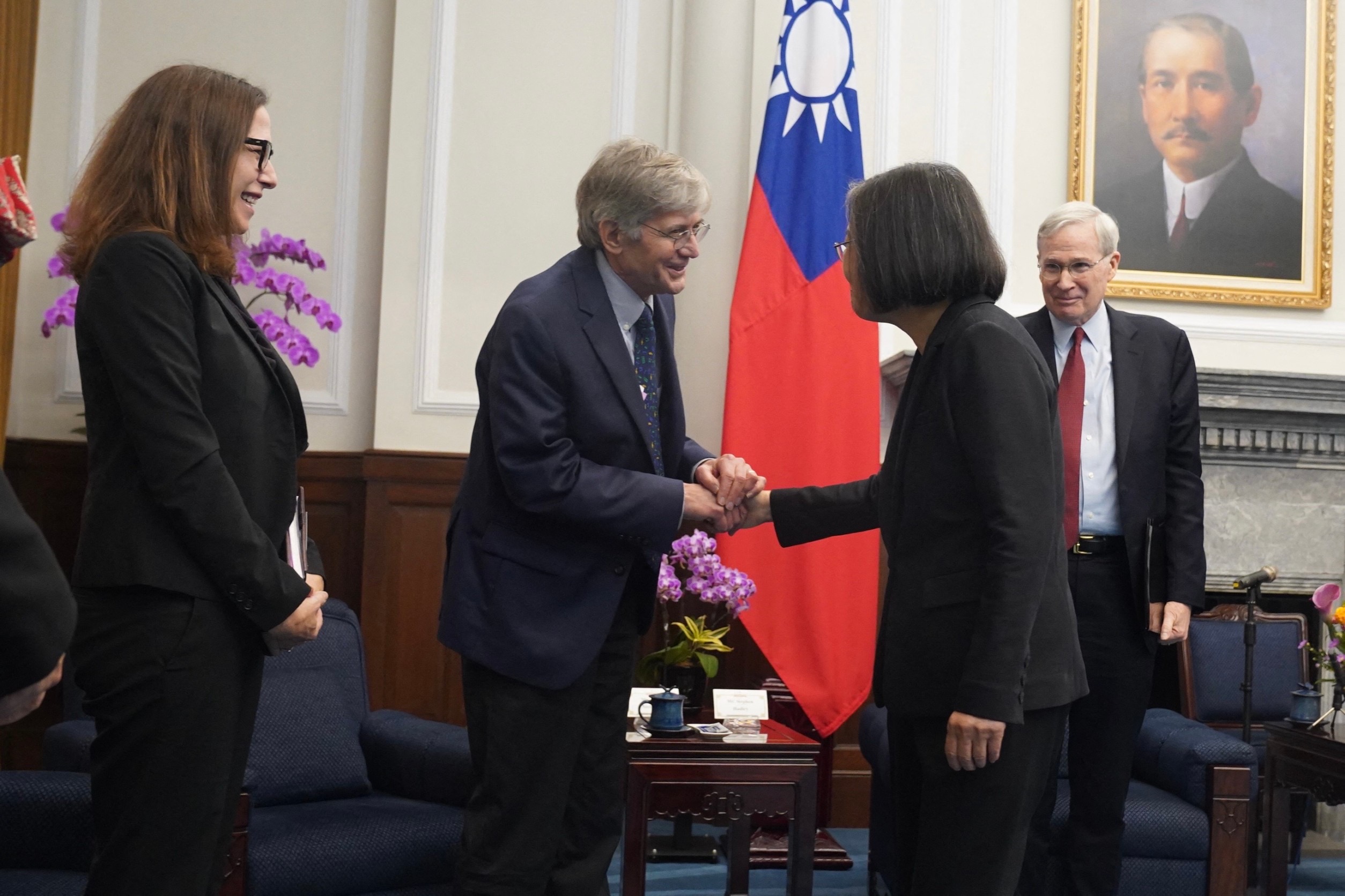 Tsai shaking hands with the visiting US delegation in her office
